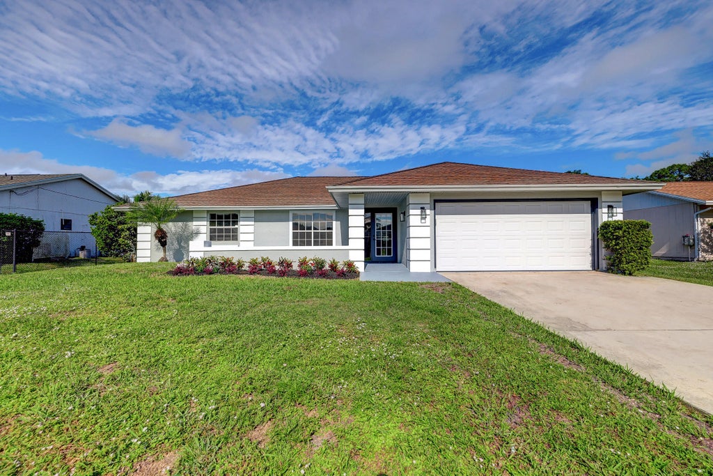 Photo of 325 SE Wallace Terrace, Port Saint Lucie, FL 34983 (MLS # B26083107)