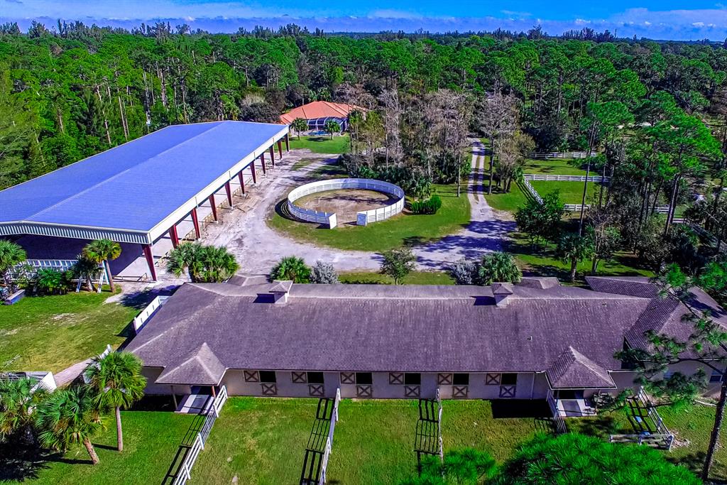 TURNKEY TRAINING FACILITY WITH BRAND NEW COVERED ARENA with GGT FOOTING!! Stunning newer 2012 upgraded POOL home 4/3.5 ON 5 ACRES. 12 STALL center aisle barn (BUILT 2012) Plenty of room for additional portable stalls, if so desired. COVERED ARENA DIMENSIONS - 220' x 90' , COMPLETE WITH DRESSAGE MIRRORS! Easily accommodates a regulation dressage arena or hunter jumper arena. FIVE PADDOCKS. 2 BR GROOM'S APARTMENT.Barn is upgraded with state-of-the-art fire sprinkler system, 12' X 14' stalls, indoor & outdoor wash racks, pest control system, FOUR INDIVIDUAL TACK ROOMS, & ONE LARGE TACK ROOM/OFFICE. Plenty of rooms to add additional stalls, if desired. Six stalls have run in paddocks. Arena is LIGHTED and IRRIGATED with MIRRORED ARENA dimensions are 220'x90'.