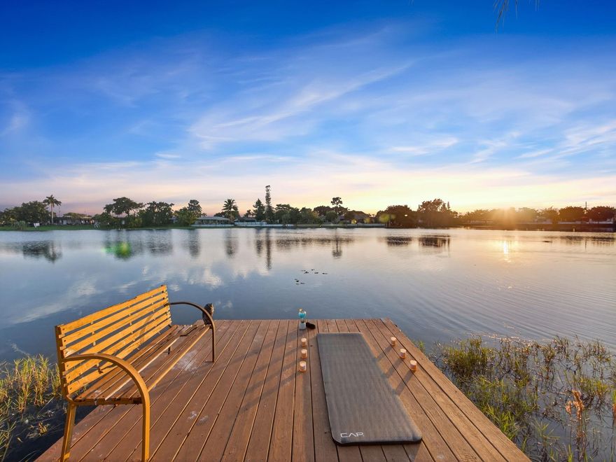 Discover a truly unique lakefront lifestyle at this 3-bedroom, 3-bath residence where every space is designed for relaxation, entertainment, and waterfront enjoyment. A peaceful cul-de-sac, this home sits on a pie-shaped lot offering panoramic views. Step outside and experience one of the most impressive backyards in the area. Features a resort-style backyard with a pool, tiki hut, dock, covered grilling station, outdoor bar, deck, and access to kayaking on the lake. Bright open-concept kitchen/living area with granite counters, wood cabinets, large walk-in pantry, a dedicated coffee bar area adds a charming, functional touch for daily comfort and spacious primary suite and split floor plan. GYM Room + shed provides excellent storage. Metal roof 2021, HVAC 2019, tankless water heater 2020.