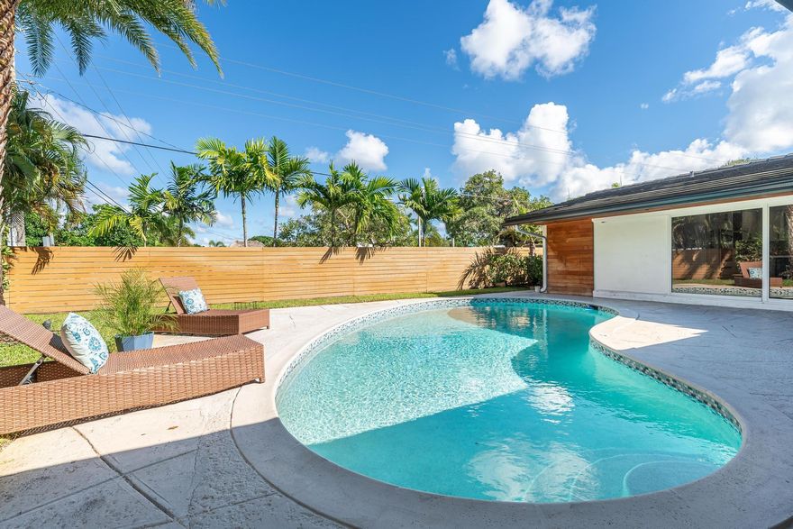 Welcome home at this beautifully updated 3BD/2BA single-family home in sought-after Imperial Point! Enjoy an open-concept layout with a chef’s kitchen featuring quartz counters, stainless steel appliances, and an oversized island perfect for entertaining. Large sliding glass doors lead to a private tropical oasis with lush landscaping and a sparkling pool. Spa-style bathrooms, modern finishes, in-unit laundry, and covered carport. Fully fenced yard offers privacy and room to relax. Located minutes from beaches, dining, shopping, and various schools. Pet-friendly with approval. A true rental gem in East Fort Lauderdale.
