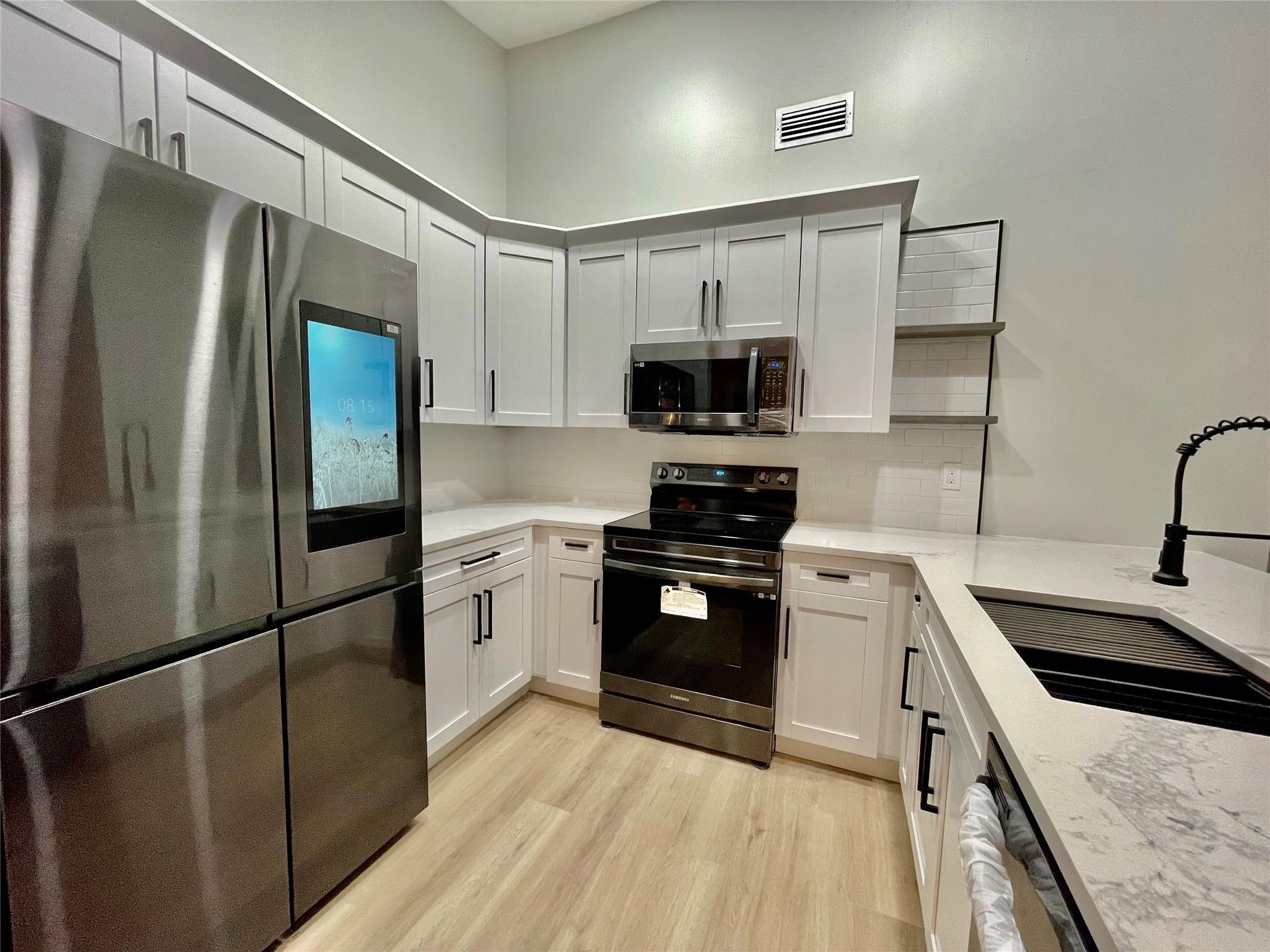 Financing fell through. Appraised at 340k. Warm & welcoming, this beautifully renovated villa will be your blissful retreat from the busy work week. From its elegant high ceilings to its white grey wood style floors with 5 inch baseboards, shaker wood doors & large walk in closets, you will agree this home has a lot to offer. The kitchen features new Samsung black stainless-steel appliances, white Calacatta quartz counters, slow close custom wood cabinets, deep matte black sink with grill, cutting board and drying rack, white subway tiles & stylish grey open shelves. The washer & dryer are conveniently located in its own utility room with ample storage. Located in a sought after, serene, pet friendly, all ages community. Springdale offers a large pool, clubhouse, party room & tennis court.