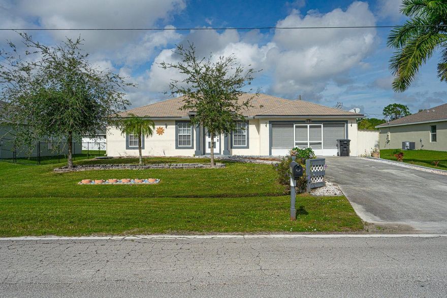 Discover comfort and convenience in this charming residence located just minutes from St. Lucie West's shopping, dining, and entertainment. This CBS-constructed home features a split floor plan, formal living and dining areas, and an enclosed screened back porch perfect for relaxing.Enjoy practical upgrades like a newer A/C, tile throughout main areas, carpeted bedrooms, alarm system, well and sprinkler system, two sheds, and hurricane panels (metal & fiberglass). Plus, there's plenty of yard space, perfect for outdoor fun!