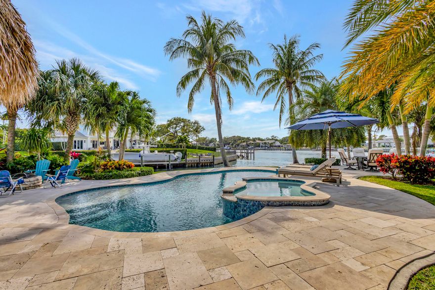 Welcome to your dream home! This rare intracoastal point property boasts unparalleled luxury and stunning waterfront views. Built in 2018, this 4-bedroom, 4-bathroom pool home offers the ultimate in waterfront living. With over 300 ft of water frontage and over 700 ft line of site across the intracoastal, this home features a deep water dock with no fixed bridges in a no wake zone, one private boat lift on a 60 ft. dock, and two jet ski lifts. Over 2,000 sq. ft of outdoor deck and walkways, you'll enjoy endless entertaining with your tiki and full outdoor kitchen. Inside, two primary bedrooms (one upstairs & one downstairs) offer privacy and comfort. The upstairs primary bedroom includes a separate living area and a big outdoor balcony where you can enjoy spectacular sunset views.. Modern finishes in the bathrooms and kitchen with high-end appliances. Porcelain tile throughout the living area with carpet in the bedrooms. Two additional bedrooms and a den/office downstairs complete this exquisite home, offering the ultimate waterfront lifestyle.