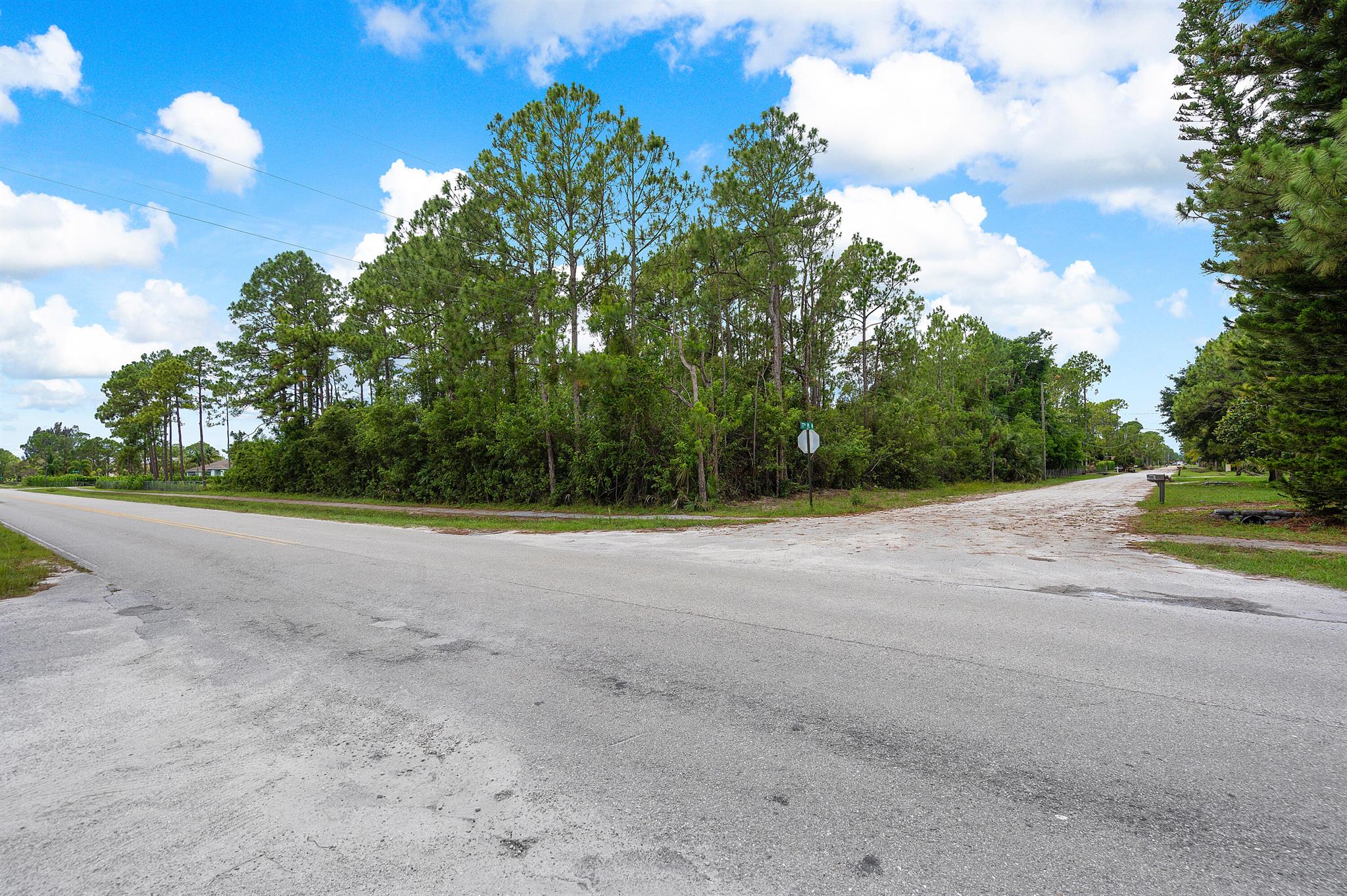 On PAVED road, corner lot, build your dream home on this beautiful lot, close to Seminole Pratt Whitney Rd and Northlake; located in the corner of Hall Blvd and 77th