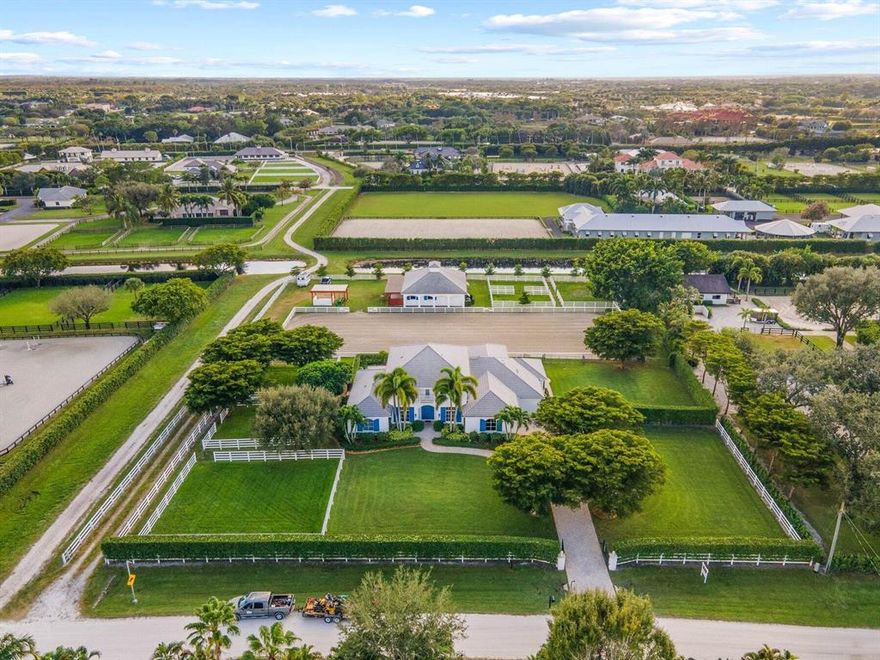 This Saddle Trail equestrian estate sits on just over 2 acres! The 2-story house features 5 bedrooms (plus an office) & 5-1/2 bathrooms. The primary bedroom is located on the first floor. Home has a formal living room & dining room, and wet bar. The pool area is extremely relaxing and there is a screened in porch. The center aisle 4-stall barn comes complete with a tack room, full bathroom & kitchenette.  Each stall is 12'x13' with fly spray & fans. The Wordley Martin riding arena is regulation dressage. There are 6 paddocks and plenty of room for your horses to roam! Don't let this exceptional property pass you by!!