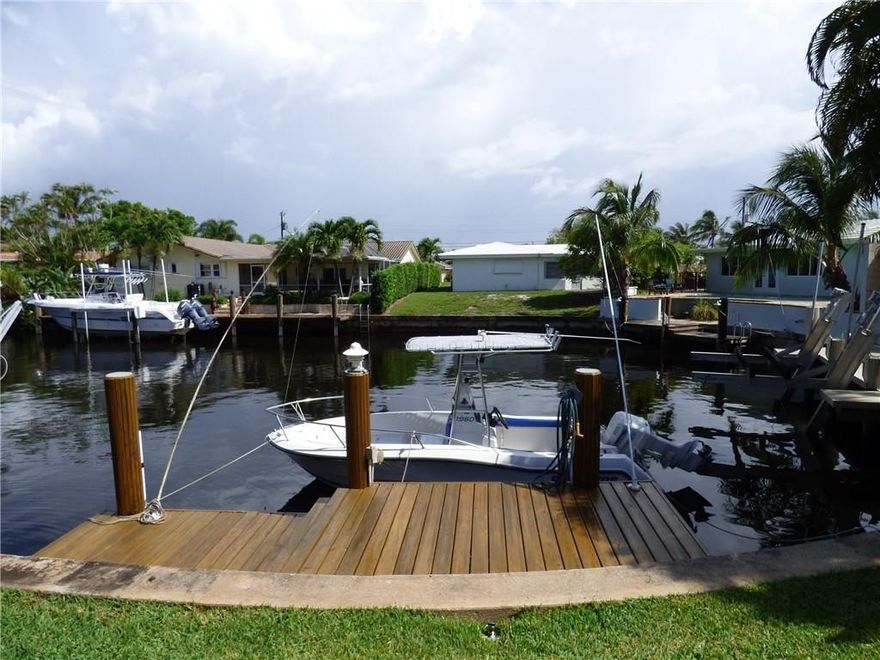 This sprawling corner home is located in a wonderful neighborhood just west of US 1 in SE Pompano Beach. Situated on an enormous 1/4 acre+ waterfront lot (1 FB, 40' on H2o), the possibilities are endless.  This home offers a sought after split bedroom plan, & extremely spacious common living areas including a media room by 2 of the bedrooms, a spacious living room with a beautiful view of the pool, & a wonderfully updated open kitchen and dining area also overlooking the pool.  Newer roof & mostly impact.