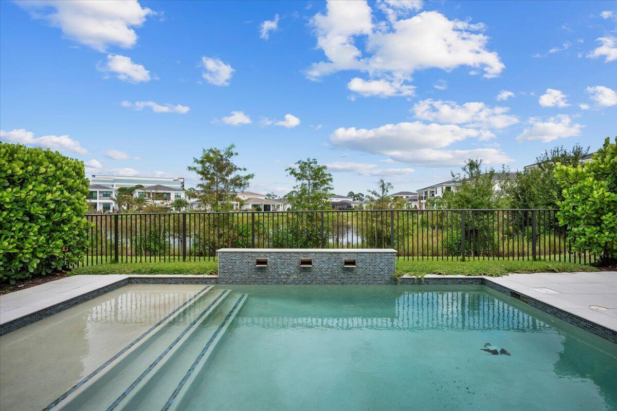 Artistry's most upgraded one story estate home. Michelangelo model on a premium lakefront lot in the center of the neighborhood. 3 bedrooms + Den and 3.5 bathrooms, 3 car garage with 3,000 sq. ft. of luxurious living space. Enjoy breathtaking views while enjoying the gorgeous pool and relaxing on the patio adorned with elegant porcelain pavers and featuring an abundant covered area with a phantom screen and summer kitchen. Inside, every upgrade has been meticulously implemented including custom built-ins, spectacular master closet and upgraded cabinetry throughout, providing modern comfort and style at every turn. Kitchen features quartz waterfall counters and backsplash and a 48'' built in refrigerator. Whole house generator, garage cabinets, central vac and a/c one car garage.