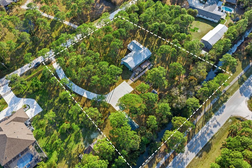 Welcome to modern elegance in Jupiter Farms! This stunning 5-bedroom, 3-bathroom home seamlessly blends award-winning sleek design with natural tranquility situated on a 1.77 acre lot. Inside, you'll find a remodeled kitchen with a propane stove, updated flooring, and a newer A/C system.
Outside, enjoy the expansive land, a newly paved driveway, RV storage with a convenient turnaround, and two versatile sheds, all surrounded by lush greenery. Relax on the wrap-around porch or entertain on the spacious back porch while soaking in the peaceful and private setting.
With beaches, golf, boating, and exceptional dining just moments away, this home perfectly captures the essence of contemporary Florida living. Call today for your exclusive tour!