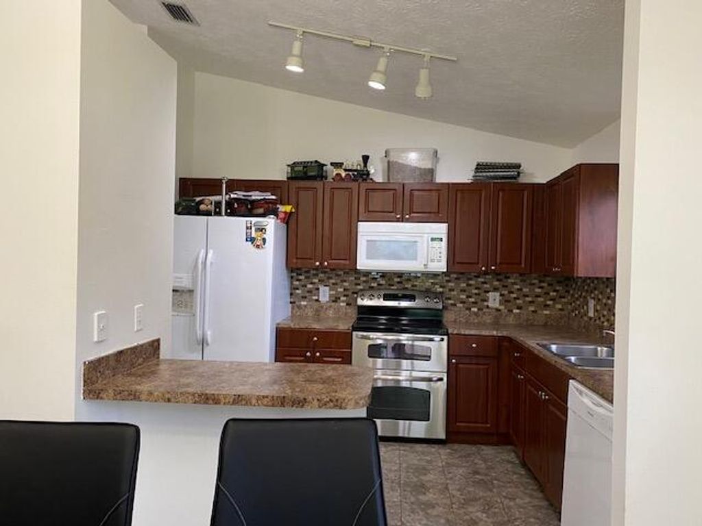 Photo of 4673 SW Joffre Street, Port Saint Lucie, FL 34953 (MLS # R10938075)