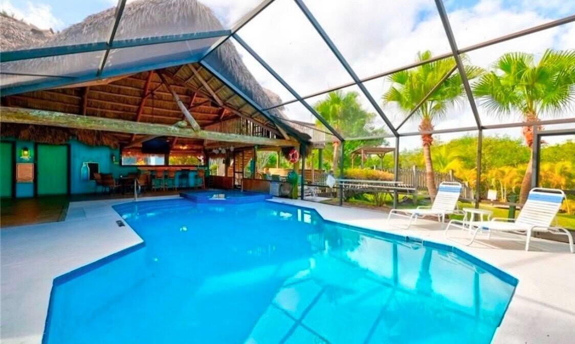 Welcome to Tropical Paradise, a great opportunity to own a unique and spacious CBS 2/2, 2nd floor villa w/garage nestled in a secluded key west style waterfront community of Walden Woods. A hidden gem surrounded by Florida nature preserve and Hawley Creek. This home is light and bright with 2 screened patios to enjoy. Many of the outstanding features are: tile floors, vaulted ceilings that are not available on a first floor unit, crown molding, ceiling fans, white kitchen cabinets and a pantry. Split bedroom plan. Guest bedroom is cozy with a loft to fit many needs. Newer SS refrigerator, dishwasher, stackable washer & dryer, hot water heater, A/C & hurricane shutters, plus a new roof in 2024. Exterior painting for the building is planned. You are just steps away from the awesome heated