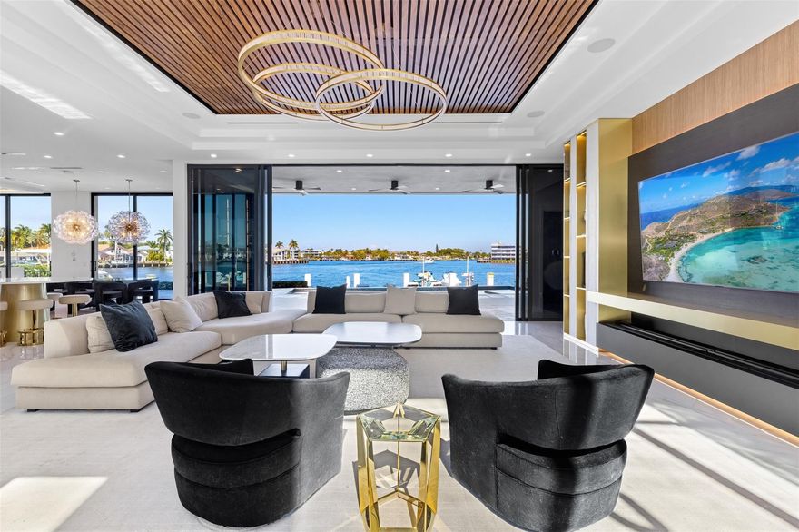 Positioned along 90 feet of prime Intracoastal frontage, this newly completed coastal contemporary estate is defined by its unobstructed, open bay views. Expansive walls of glass dissolve the boundary between indoors and out, capturing sweeping vistas from nearly every room and filling the home with natural light from sunrise to sunset.Thoughtfully designed for both refined daily living and elevated entertaining, the open-concept interiors are anchored by a dramatic architectural staircase and enhanced with bespoke finishes throughout. A chef’s kitchen with a full catering pantry, private theater, home office with floor to ceiling glass and waterfront bar complement the seamless flow to the resort-style pool terrace, where fire features and a summer kitchen overlook the wide-open bay.