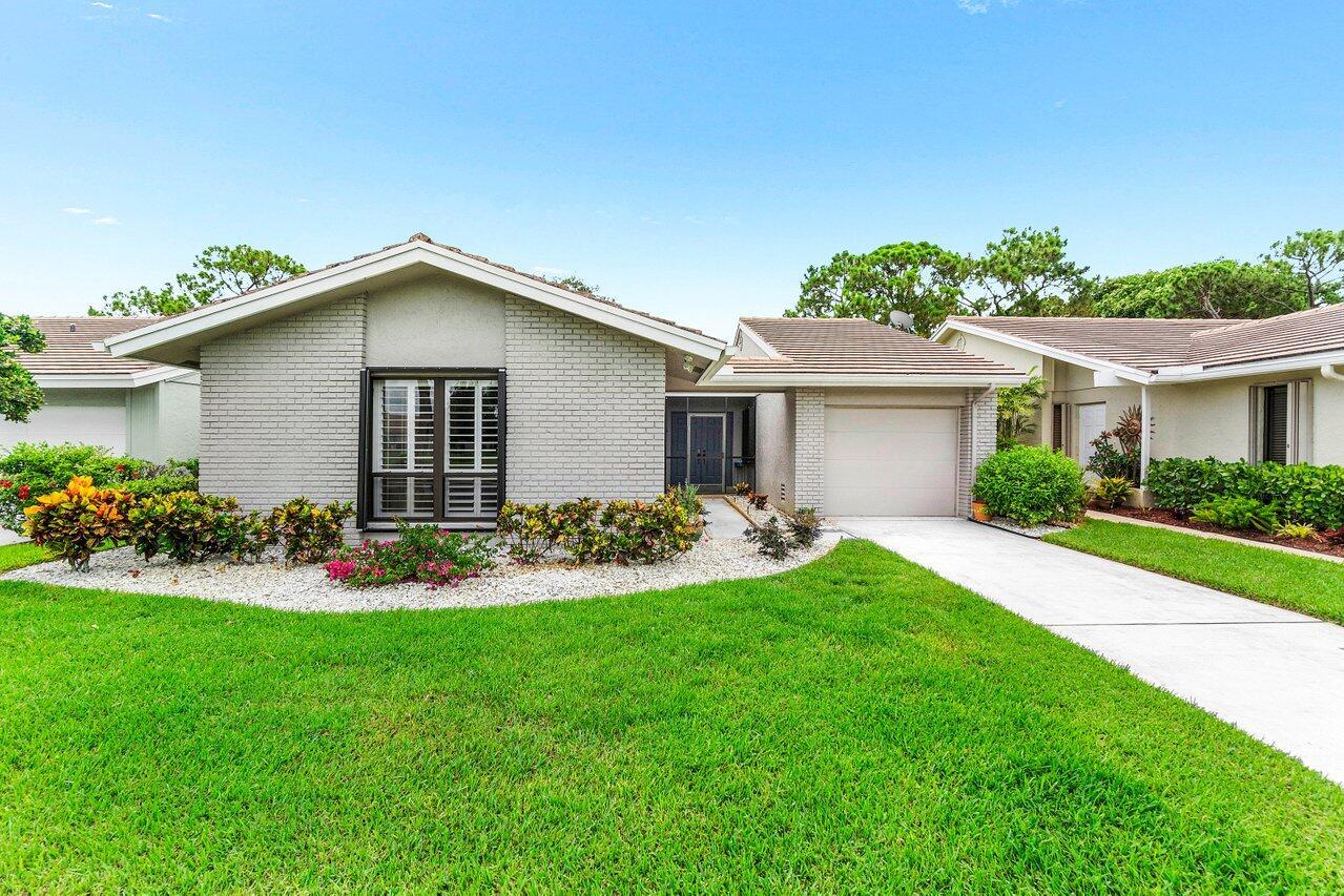 Enjoy 1-story living w/ gorgeous open views of the 17th fairway! CBS home w/ a combo of hurricane impact windows and Accordian shutters for easy breezy storm prep! Lovingly cared for and move-in ready. If you like a large living area and open, soaring ceilings - this one is for you! Double door entry greets with grandeur and makes moving simple. Light and bright with Southeastern views. Thoughtfully remodeled to include a new kitchen w/ white shaker style cabinetry, granite counters, stone backsplash & newer appliances including a Bosch dishwasher and 2025 refrigerator. Breakfast bar and dining area perfectly suit entertaining or meals for one. Floors have new tile throughout - no carpet! Bathrooms have also been updated w/ new vanities, new shower tile and glass enclosures.