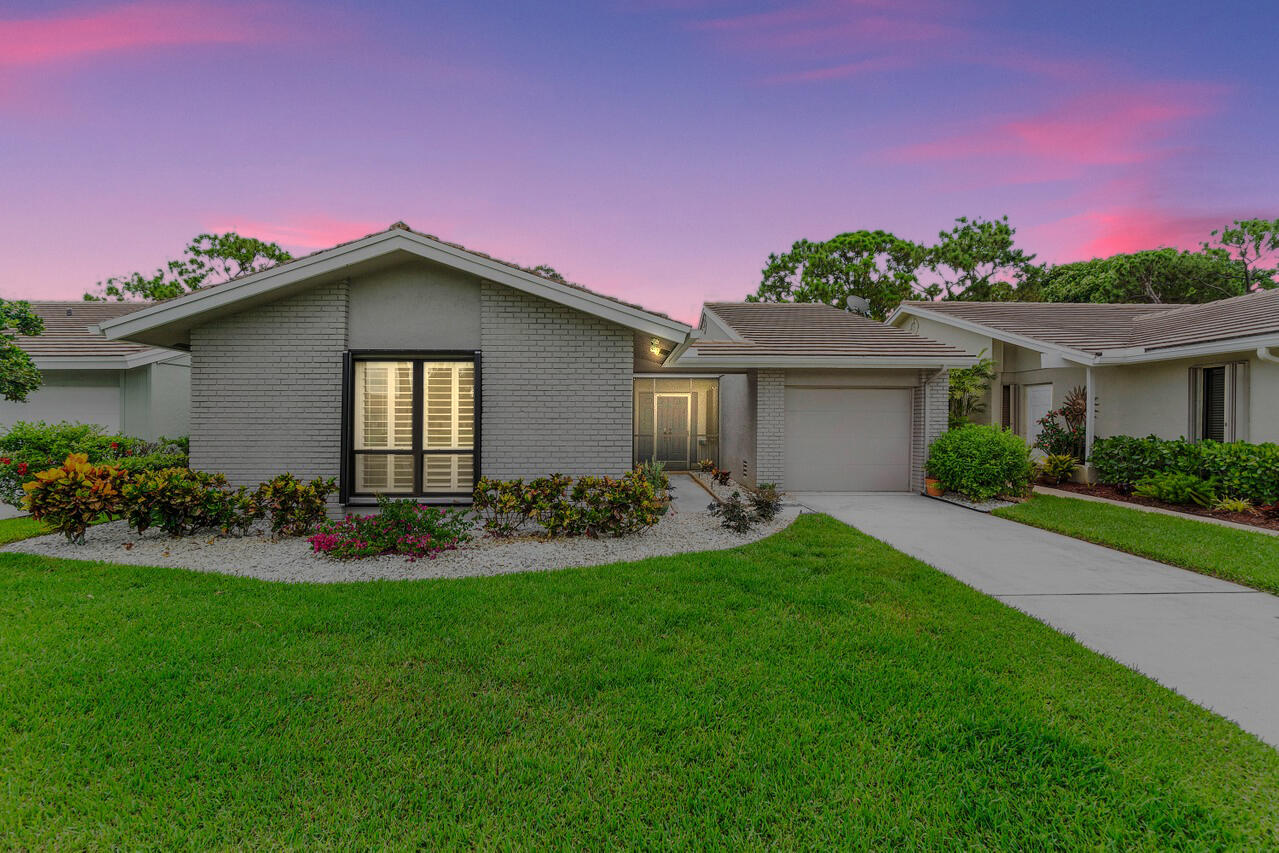 Enjoy 1-story living w/ gorgeous open views of the 17th fairway! CBS home w/ a combo of hurricane impact windows and Accordian shutters for easy breezy storm prep! Lovingly cared for and move-in ready. If you like a large living area and open, soaring ceilings - this one is for you! Double door entry greets with grandeur and makes moving simple. Light and bright with Southeastern views. Thoughtfully remodeled to include a new kitchen w/ white shaker style cabinetry, granite counters, stone backsplash & newer appliances including a Bosch dishwasher and 2025 refrigerator. Breakfast bar and dining area perfectly suit entertaining or meals for one. Floors have new tile throughout - no carpet! Bathrooms have also been updated w/ new vanities, new shower tile and glass enclosures.
