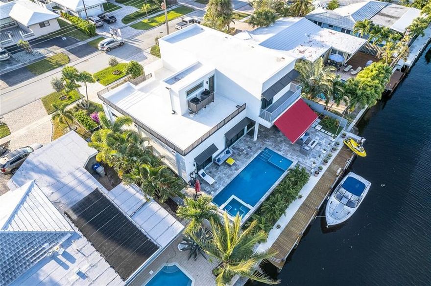 Stunning 2020 build with 4 bedrooms and 4 bathrooms. Ultra modern open floor plan with floating staircase with commercial grade glass. Massive rectified porcelain throughout the downstairs and finished in the garage. Impact glass windows and doors throughout elevator construction, beautiful 65 foot dock and 75 feet on the waterfront. Stunning bathrooms, master downstairs And three bedrooms upstairs. The best part of all is the rooftop terrace over the whole property. Dual AC units all the bells and whistle’s!