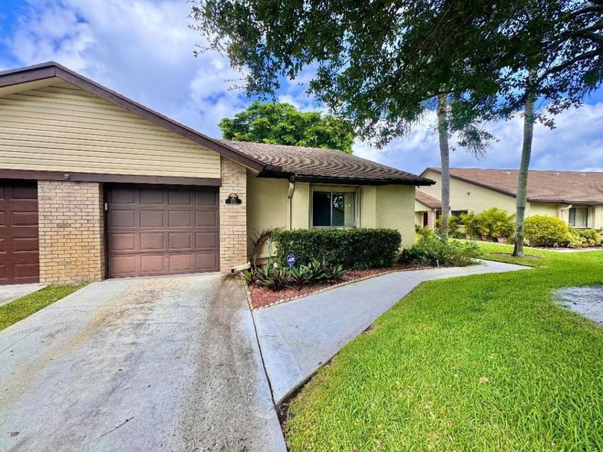 Don't miss this opportunity to own a bright and spacious 3-bedroom, 2-bath corner villa with a garage in the highly sought-after 55+ community of Village Walk in Royal Palm Beach. This one-story home offers vaulted ceilings, a skylight, tile flooring throughout, and accordion hurricane shutters for peace of mind. NEW HVAC 2025.

The renovated kitchen features cream-toned cabinetry, granite countertops, a large island with bar seating, and stainless steel appliances, flowing seamlessly into the open living and dining areas. A mudroom with full-size washer and dryer adds convenience.

The enclosed, air-conditioned patio creates a generous Florida room with tranquil canal views, also enjoyed from the kitchen, living room, and primary bedroom. The primary suite includes a walk-in closet and a beautifully updated bathroom with a step-down shower and safety handrail. Two additional bedrooms, including one with a walk-in closet, and a guest bath with a tub/shower complete the layout.

The HOA replaced the roof in 2013 and covers roof maintenance, lawn care, exterior and sprinkler maintenance, basic cable, and more. Community amenities include a pool, spa, clubhouse, walking paths, and picnic area.

Ideally located across from Commons Park and minutes to shopping, dining, hospitals, major highways, PBI Airport, and beachesthis home offers comfort, convenience, and low-maintenance living.