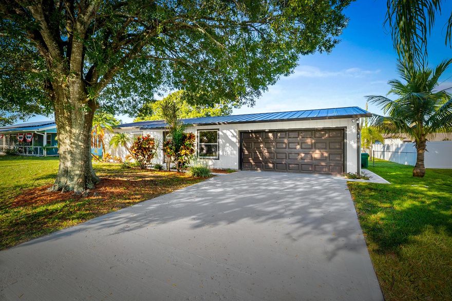 Welcome to this beautifully updated 2BR/2BA home in the heart of Port St. Lucie! Featuring a NEW ROOF, NEW water heater and newer A/C this move-in-ready property blends charm and modern convenience. Inside, enjoy a bright open layout with new flooring in both bedrooms and fresh neutral paint throughout. The kitchen offers brand-new stainless steel appliances and abundant counter space, perfect for everyday cooking or entertaining. The spacious screened patio overlooks a large, fenced backyard ideal for relaxing or hosting gatherings. Additional highlights include a freshly epoxied garage floor and mature landscaping for great curb appeal. Conveniently located near shopping, dining, parks, and beaches, this home is a must-see!