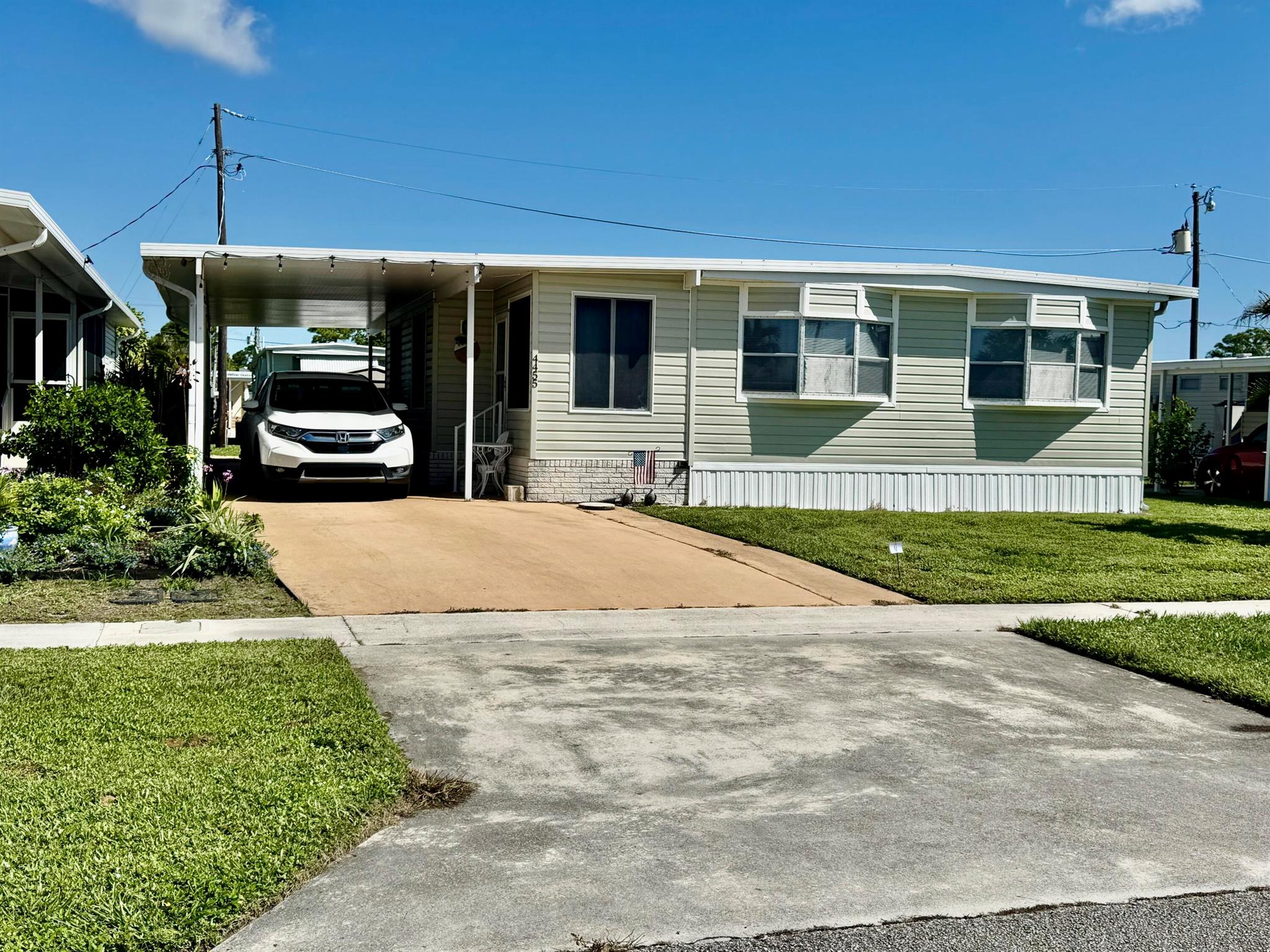 Opportunity knocks with this charming furnished and turnkey mobile home in the highly desirable Tropical Breeze Estates 55+ active adult community! Boasting 1,224 sq ft under air, this 2-bedroom, 2-bath home features a Florida room with AC, a covered backyard patio, shed, and carport, perfect for enjoying Florida's sunshine and relaxed lifestyle. Step inside to a brand-new kitchen with stainless steel appliances, fully updated bathrooms, and vinyl wood-look flooring--no carpet. Includes a golf cart, large washer and dryer, newer AC, and a roof over for extra protection. Extremely clean and well-maintained, ideal for snowbirds, retirees, or full-time living. Don't wait--homes in this community sell fast! Call today to schedule your private or virtual tour and make this home your