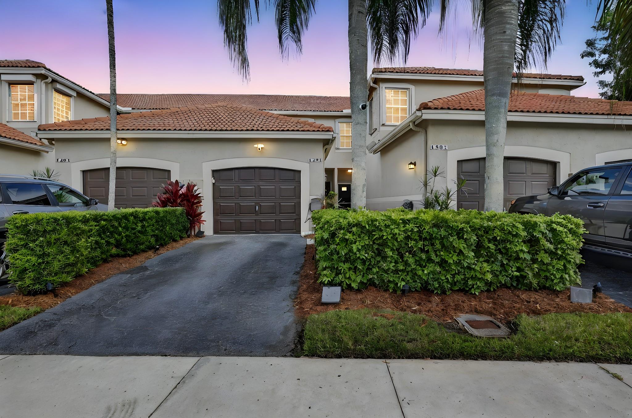 Gorgeous 2/2 Townhome in the gated community of San Remo! New Roof is currently being installed! Kitchen & baths completely updated! The spacious kitchen features quartz counters, stainless Samsung appliances, pullouts, large French Fridge, Moen faucet & snack bar.  IMPACT GLASS THROUGHOUT! Natural light fills the home, which features new luxury ceramic "wood look" tile in all the main living areas, newer A/C with new ducts, newer water heater, new gutters, new fences, Bally blinds, and custom closets in all bedrooms. 2022 Samsung washer/dryer in garage. Breathtaking wide lake view from your screened rear patio! Community just updated the pool; playground, & BB court! Great community spirit! Weston features top rated schools, sports fields, parks, & more! One Year FREE AHS Warranty! Hurry!