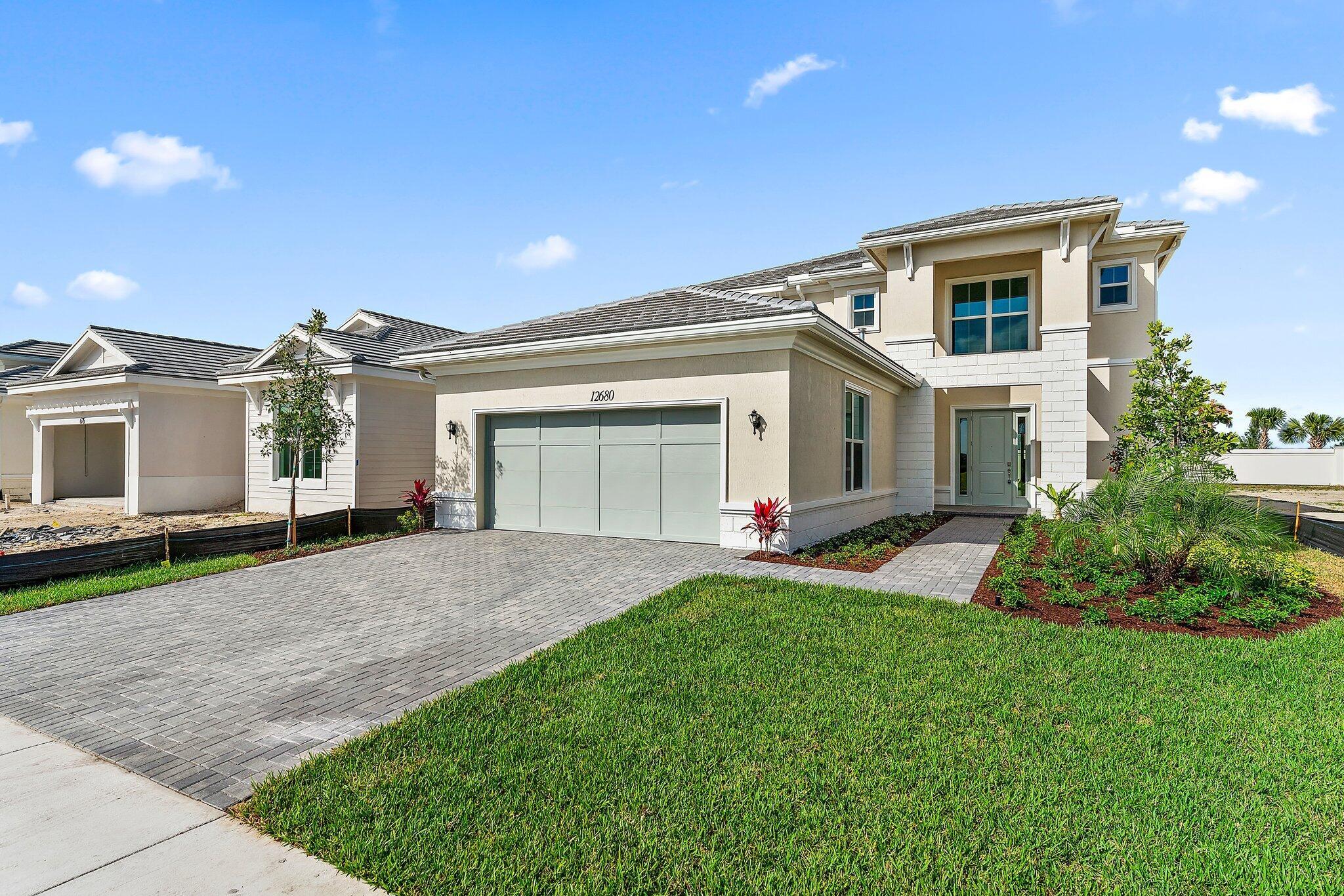 Absolutely Stunning biggest Roland Model At the Wonderful Gated Community Of Windgate At Avenir. Offering 5 Bedrooms, 3.5 Bathrooms, and 2 Car Garage. Step Inside This Magnificently Upgraded Home With Neutral Wood Look Tile Floors And Open Concept Kitchen That Overlooks the Family Room. The Kitchen Boasts Wood Shaker Style Cabinetry With Modern Hardware, White Quartz Countertops, SS Appliances, GAS Cooktop, and Spacious Pantry. ALL Impact Windows & Doors, RECENTLY renovated with Luxury vinyl floors (no carpet!)