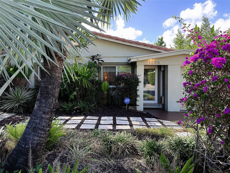 This "Jewel Box" mid-century modern, has been lovingly restored.  Step inside where past meets present with a fully remodeled kitchen, fitted with Stainless appliances, including a gas range for cooking enthusiasts.   Making your way around the home notice how light reflects off the Polished Terrazzo flooring.  Some other highlights of this special place include updated bathrooms, impact windows thru-out, impact glass doors, hurricane rated garage door, and a tankless hot water heater.  Stepping out the back doors, we are greeted with an expansive backyard w/ privacy fencing, natural green hedging & huge mature trees.  Plenty of room for you and/or your pets to roam! If a pool is what your considering, there is plenty of room to add one!   Don't let this one get away from you!