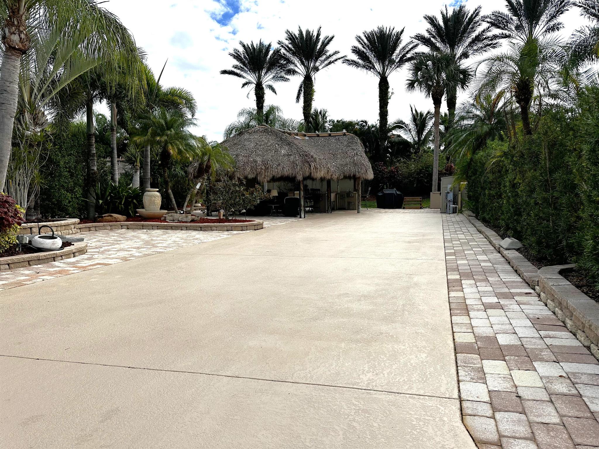 Motorcoach Resort St Lucie West! One of the largest lots in Phase One with no RV lot opposing view! Easy back in access! Newer refreshed LARGE Tiki with new kitchen, granite and appliances including water heater. This large lot has a nice balance of concrete and pavers in all the entertaining areas! Nicely landscaped with thoughts for golf cart area parking and uncovered entertainment space! Electric screens help keep the elements out. Includes furnishings and storage units. Plenty of room for your 45' rig, vehicles and golf cart. Green space for pets. Currently in the rental program. Close to the main entrance, clubhouse and pool. ''Class A'' Paradise!