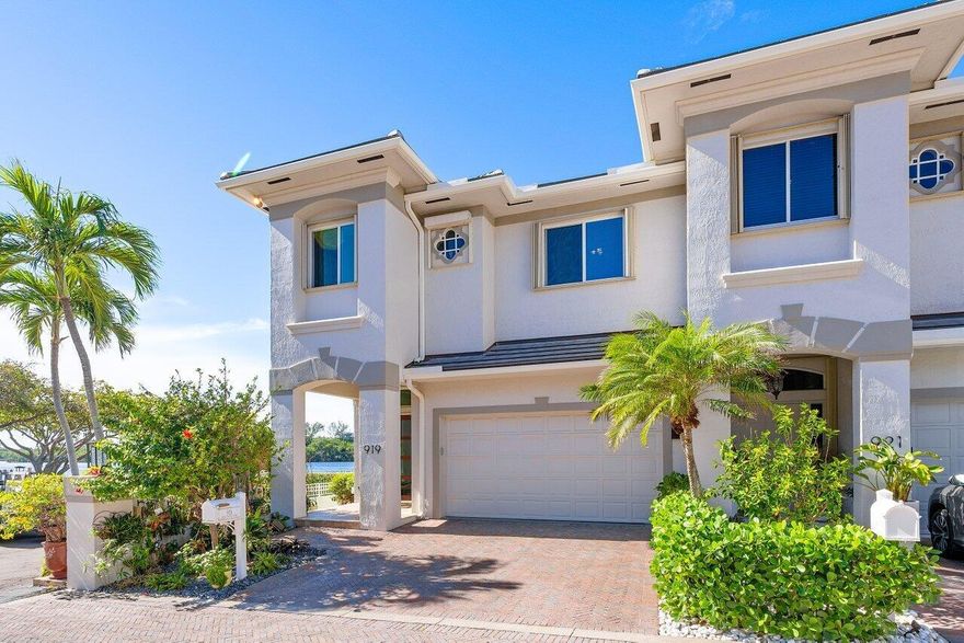 Outstanding, waterfront four bedroom townhome (end unit) with soaring ceilings, private pool and 2 car garage, assigned boat slip and deeded beach access. Breathtaking panoramic views spanning 3/4 mile with unobstructed sightlines of the expansive waterway from every room. Enjoy these vistas of the wide section of the intracoastal through generously-sized solar shield impact glass windows. Totally open gourmet kitchen that overlooks the family room, deck, private pool, boat dock and that amazing view. Huge waterfront primary suite with massive closet. Completely renovated primary bath features a high end jacuzzi tub, spa-like shower, custom cabinets, granite countertops and beautiful intracoastal views. Intimate townhome community walking distance to deeded beach access.