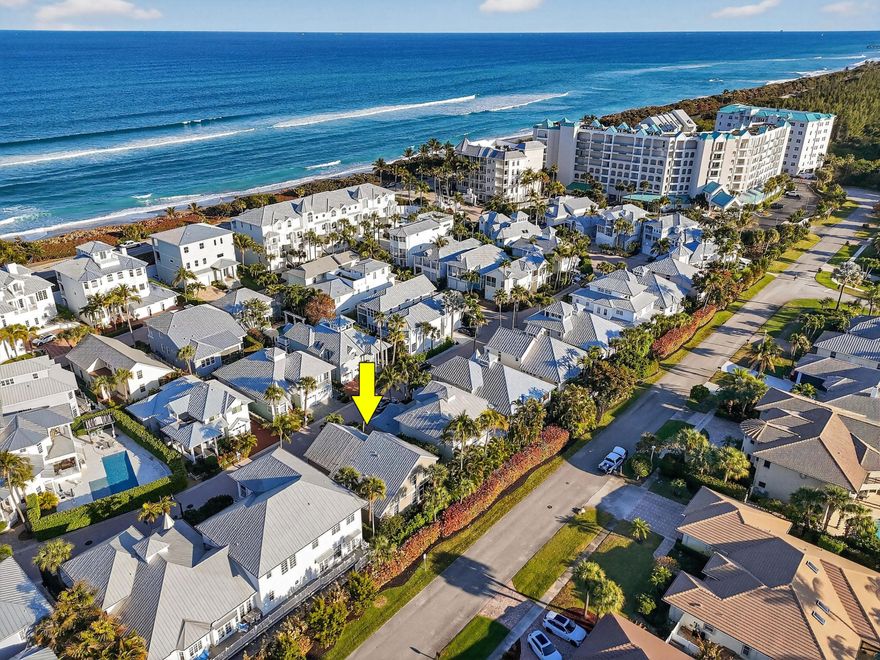 Tucked within the intimate, gated seaside enclave of Jupiter Key, just steps from the Atlantic shoreline, this Key West-style residence offers a rare opportunity to own within one of Jupiter's most charming and tightly held coastal neighborhoods. Positioned along a quiet, palm-lined drive directly across from one of the area's few dog-friendly beaches, the setting feels less like a residential development and more like a private coastal village. Morning walks to the ocean, sunset strolls along the sand, and effortless access to beachside dining, fitness, and cultural venues define daily life here. This is a place where the lifestylenot densitysets the tone.

Spanning approximately 2,192 living square feet, the residence offers three bedrooms, two full baths, and one half bath, including a desirable main-level primary suite. Soaring cathedral ceilings and expansive impact windows flood the interiors with natural light, while French doors open to a screened tropical porchcreating seamless indoor-outdoor living and embracing the relaxed rhythm of Jupiter's coastal environment.

The kitchen is functional and inviting, featuring granite countertops with a full-height granite backsplash, stainless steel appliances, custom wood cabinetry, and generous prep space. An eat-in breakfast area flows naturally into the family room, creating a connected gathering space ideal for everyday living or hosting after a day at the beach.

The primary suite enjoys tranquil garden views, tile flooring, and a customized walk-in closet with built-in shelving and cabinetry. The en-suite bath includes dual vanities with granite counters, a soaking tub, and a frameless glass walk-in shower with bench seating. Upstairs, a spacious loft offers flexible living space well suited for a home office, media lounge, or additional guest retreat, while secondary bedrooms are comfortably proportioned and filled with natural light.

Outdoors, the screened porch with wood decking and ceiling fan is framed by mature palms and lush tropical landscaping, offering a quiet extension of the living space. Brick paver walkways, classic island architecture, durable Hardie board siding, and a 2017 metal roof reinforce the home's enduring coastal character. A one-car garage provides convenience and additional storage.

While the residence presents an opportunity for thoughtful modernization, its volume ceilings, floor plan, and structural integrity offer exceptional bonesan ideal foundation for reimagining a bespoke beach retreat in a location that cannot be replicated.

Jupiter Key offers a rare blend of privacy and walkability, with a community pool and direct beach access just moments away. From boating and waterfront dining to boutique shopping, theater, and Palm Beach International Airport, everything that defines Jupiter's coastal lifestyle is within easy reach.

In a market defined by the scarcity of true walk-to-the-ocean residences, this property represents an opportunity to secure location, lifestyle, and long-term value within one of Jupiter's most desirable seaside enclaveswhere every day feels like a retreat.