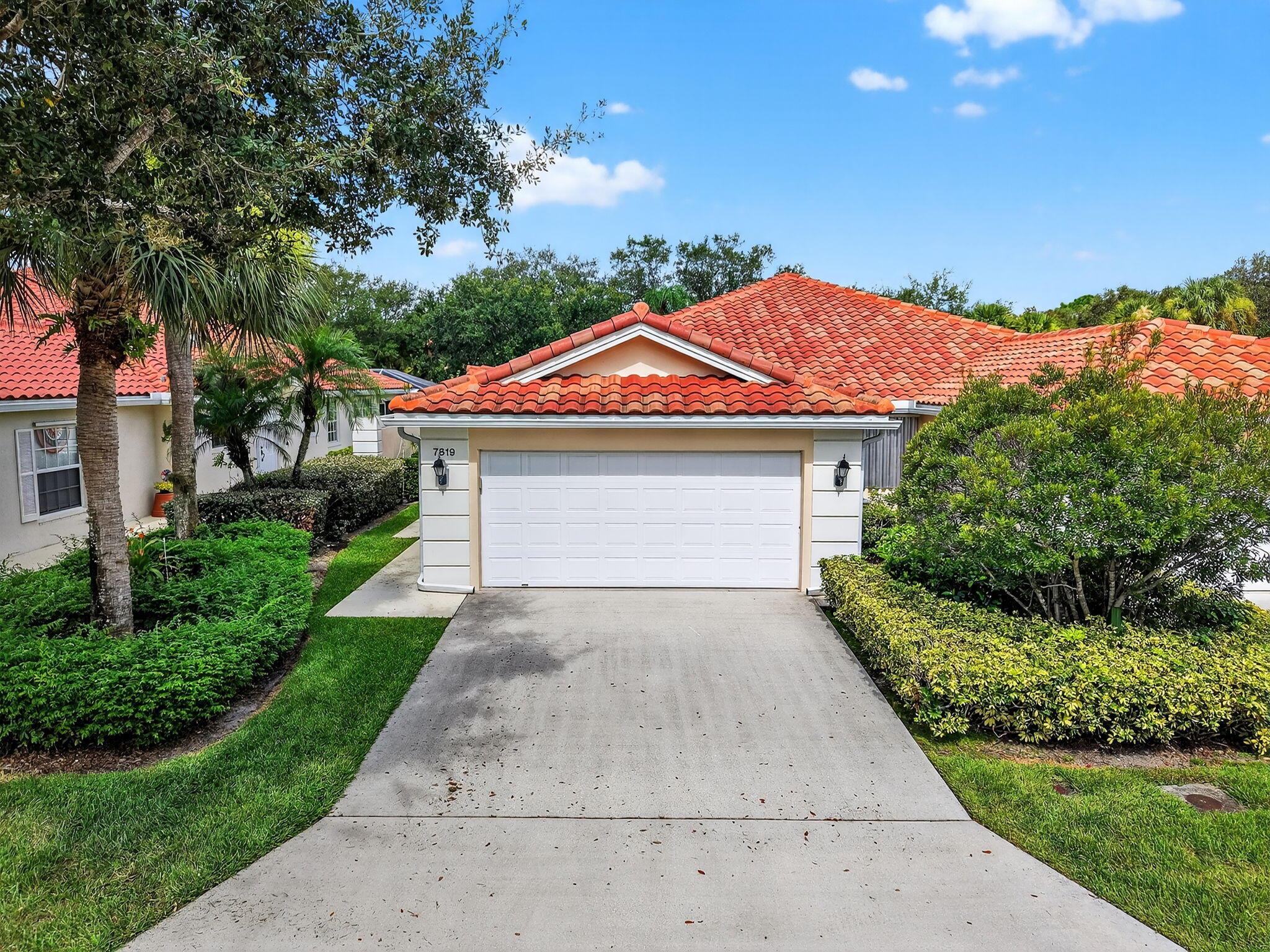 Beautifully maintained 2BD/2BA villa with a 2-car garage in the highly desirable, resort-style community of RiverWalk. This light-filled home backs to a peaceful nature preserve and offers a spacious, open layout with vaulted ceilings and stylish modern tile flooring throughout. The split-bedroom floor plan provides privacy, while the screened lanai is ideal for morning coffee or evening relaxation. Recent upgrades include a 2022 roof and 2020 A/C. RiverWalk features 3 heated pools, 8 Har-Tru tennis/pickle-ball courts, a renovated fitness center, scenic walking trails, a playground, library, bocce ball, and on-site Italian restaurant. HOA includes cable, internet, landscaping, 24-hr manned gate, and more. No country club fees! Close to PBI, Turnpike, shopping, and downtown.