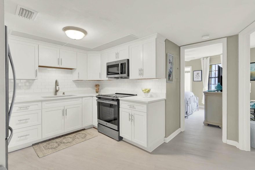 Welcome home to this FULLY and beautifully renovated 2 bed 2 bath 1st floor water view condo in Jensen Beach. Enjoy living with endless major upgrades throughout, completed in 2023. Including luxury VP flooring, fresh paint, doors, ceilings, light fixtures, fans, accordion shutters, black-out shades, air ducts/vents, AC handler/condenser, HWH, and W/D.  Kitchen features stainless appliances, quartz countertops, soft-close cabinetry. Bathrooms boast updated faucets, vanities, toilets, shower glass enclosure. Club house recently renovated, pool table, two pools (one heated), grill and picnic areas. Newer roof and mansards 2024, exterior paint planned in 2026. 1 month min rental up to 4x per year, 1 pet up to 15lb.