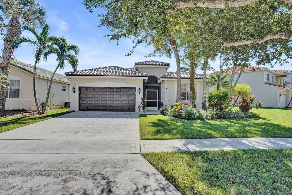 Photo of 127 Seminole Lakes Drive, Royal Palm Beach, FL 33411 (MLS # F10534753)