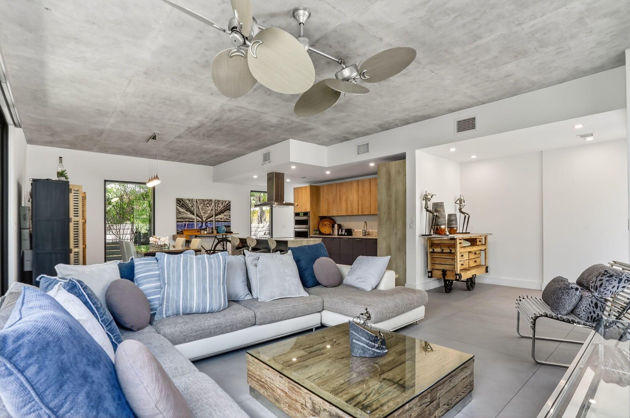 Discover the perfect blend of modern luxury, privacy, and convenience in this stunning townhouse with 2,239 sq. ft. of open-concept living space. Designed with sophistication and lifestyle in mind, this residence is ideal for those seeking a sleek, contemporary home in one of Fort Lauderdale's most desirable neighborhoods. Step inside through a custom-built stained-glass front door and be greeted by soaring floor-to-ceiling impact glass that floods the home with natural light. The spacious open floor plan is perfect for entertaining, whether you're hosting friends in your private fenced-in outdoor oasis with low-maintenance artificial grass, or enjoying a quiet evening at home. The gourmet kitchen is outfitted with top-of-the-line built-in appliances and a stylish modern design,