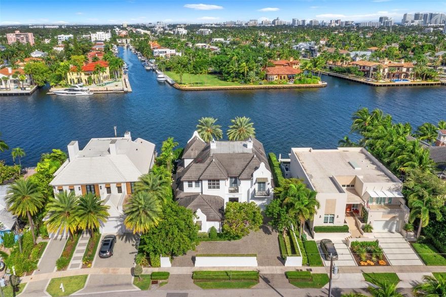 Beauty, elegance, quality, location, & sophistication define this exceptional custom-built waterfront residence. Situated on approx. 101'± of prime waterfront with direct ocean access, the home is located on the tree-lined 7th Street in Rio Vista—one of Fort Lauderdale’s most prestigious neighborhoods. Built in 2010 by Bomar Builders with an uncompromising focus on quality, this 4-bedroom plus gym, 4.2-bath, 3-garage home showcases exceptional craftsmanship throughout. Architectural highlights include vaulted wood-beamed ceilings, refined custom finishes, elegant wood moldings & cabinetry, stone flooring, temperature-controlled wine room, elevator, & automated Armor Screens. The property also features an updated alarm & camera security system, offering enhanced comfort and peace of mind.