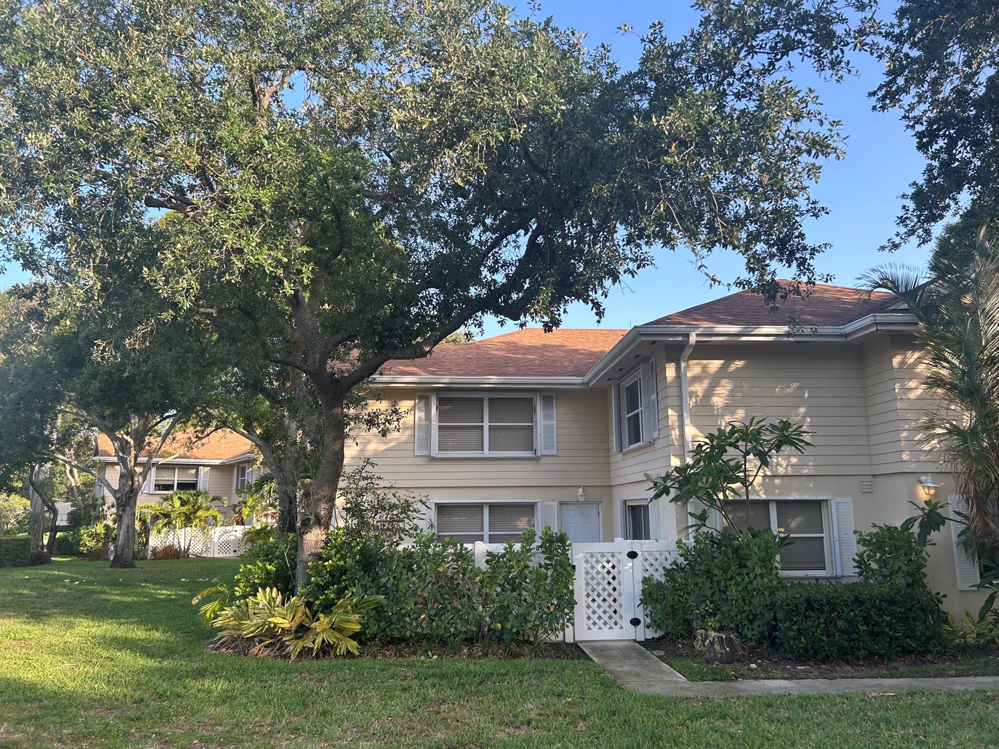 This spacious residence offers 2 primary bedrooms, each with its own private en-suite bath (renovated in 2020 & 2021). The updated kitchen (2017) showcases 42'' cabinets, upgraded appliances, sleek countertops, and a copper farmhouse sink. Additional upgrades include accordion hurricane shutters (2020), a smart Nest thermostat, and a central vacuum system. Located in a 24/7 manned, guard-gated community, residents enjoy resort-style amenities: pool, tennis courts, playground, and scenic lakefront walking paths. HOA covers cable, lawn care, community pool, pest control, manned security gate, playground maintenance, building insurance, and water--providing both convenience and peace of mind.Perfect for families and pet lovers, this home blends comfort, style, and security.