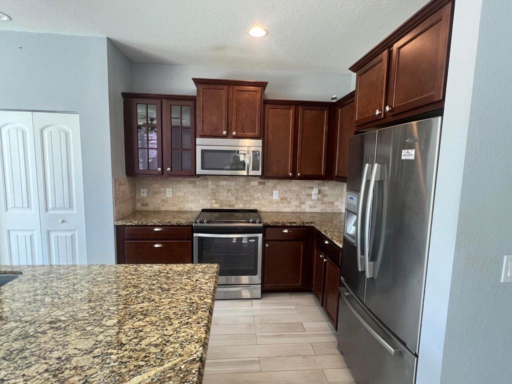 Photo of 810 Palm Tree Lane, West Palm Beach, FL 33415 (MLS # B26023717)