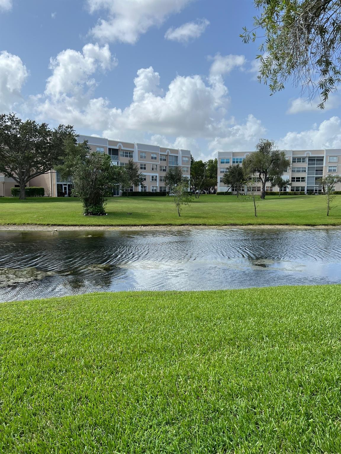 Welcome to this extended 2-bedroom, 2-bathroom condominium nestled in the Island section of the Sunrise Lakes community. Discover an enlarged living area that seamlessly flows, an interior laundry room, and an eat-in kitchen. The split bedroom plan ensures privacy and comfort. While the unit requires some updates, it presents captivating golf and water views that add to its potential charm. Residents can enjoy a rich social community with an array of amenities and features, including golf. CLOSE TO EVERYTHING. The association states this is a 55+ community.