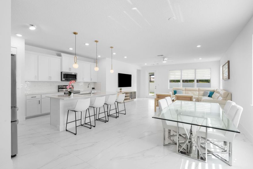 Spectacular Hidden Gem in gated Veleiros at Crystal Lake! Stunning 4 Bedroom, 3 Full Bath home with triple split layout and 2 Primary Suites. Upstairs primary suite is ideal for multi generational living, guests or office. Open concept floor plan with 24x48 porcelain tile on the 1st floor and LV on the 2nd floor, no carpet! Chefs kitchen dazzles w/ quartz counters and SS appliances, perfect for entertaining. Constructed in 2021, the CISNE model offers elegant architecture, impact windows, doors and garage doors. Enjoy the fully fenced yard with travertine patio under shaded pergola with dual fans, artificial turf, water and electric hookups for a future summer kitchen. Paver driveway for 3 vehicles (incl trucks). Resort style perks: clubhouse, beach entry pool, fitness center, playground.