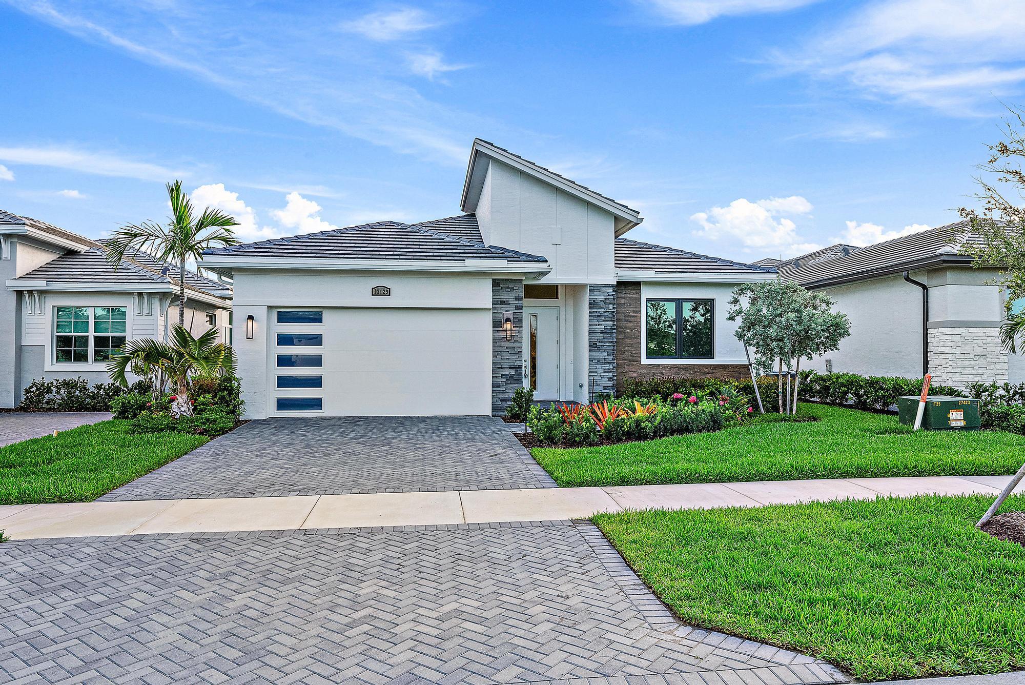 Welcome to 13129 SW Shinnecock Drive, a stunning 2024-built extended ''Jordan'' model by Kolter Homes, nestled in the highly sought-after Astor Creek Golf & Country Club. This upgraded floor plan includes a 4-foot extension to the owner's suite and main living area, offering even more space and comfort for everyday living and entertaining.Designed with both style and functionality in mind, the home features 2 bedrooms, 2 bathrooms, a spacious flex room ideal for a home office or den, and a 2-car garage with extra storage.Inside, you'll find an open-concept layout with high ceilings, luxury plank flooring, and refined finishes throughout. The chef-inspired kitchen boasts quartz countertops, 42'' upper cabinets with crown molding, soft-close drawers, under-