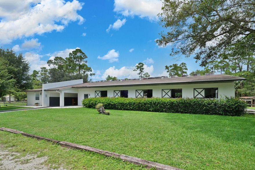 This lovely center-aisle barn has ten 12x12 matted stalls, air-conditioned tack and feed rooms, wash racks with hot water, irrigated paddocks and an arena measuring 100' X 210'. In addition to the 10-stall barn, there are 10 additional stalls, 2 with walk-out stalls that open to grassy green paddocks. This barn is hurricane safe CBS construction with roll down shutters. Included in the rental price is a 1/1 apartment. A great place for your horses to have peace and quiet while still only moments away from  Wellington International. There is 1 camper hookup available for an additional fee.  Most recent upgrades to the property include:  Reverse osmosis water system, Gazebo by the arena, Hay storage,  8 new stalls & 2 additional wash stalls and E. CITRUS DRIVE IS PAVED.