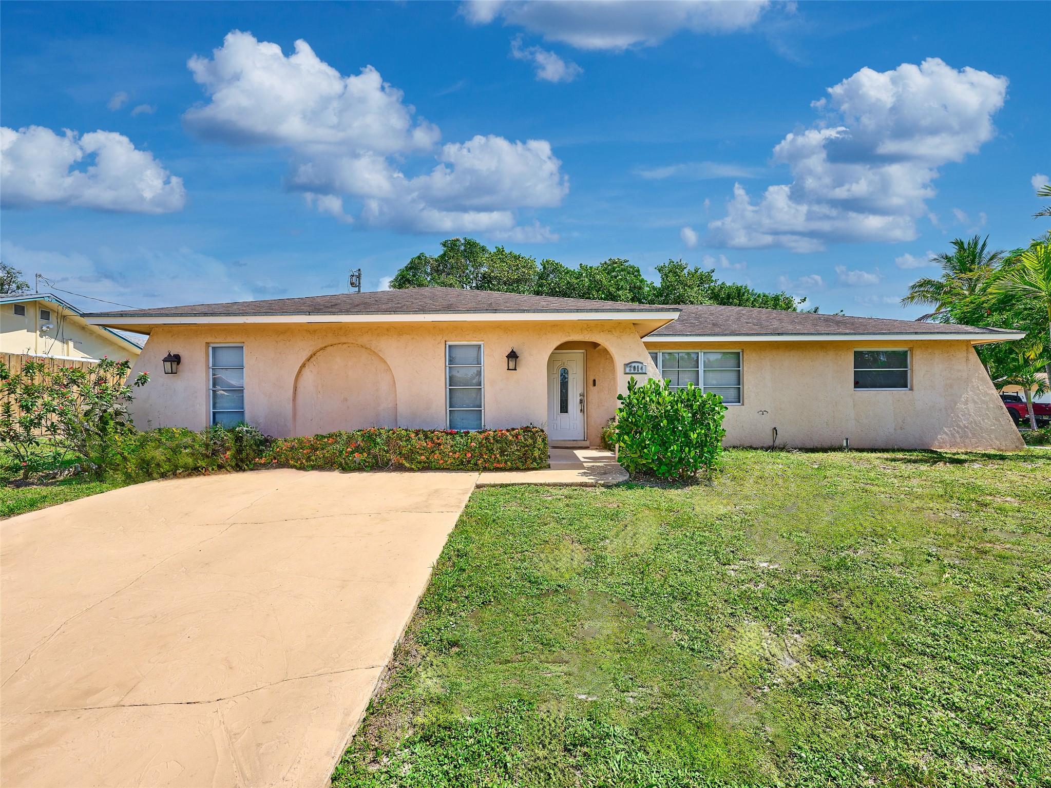 Welcome to this beautifully maintained 4-bedroom, 2.5-bathroom home, perfectly positioned on a spacious corner lot in the heart of Lake Worth. With 2,466 square feet of thoughtfully designed living space, this residence offers the ideal blend of style, comfort, and functionality—all nestled in a quiet, established neighborhood.