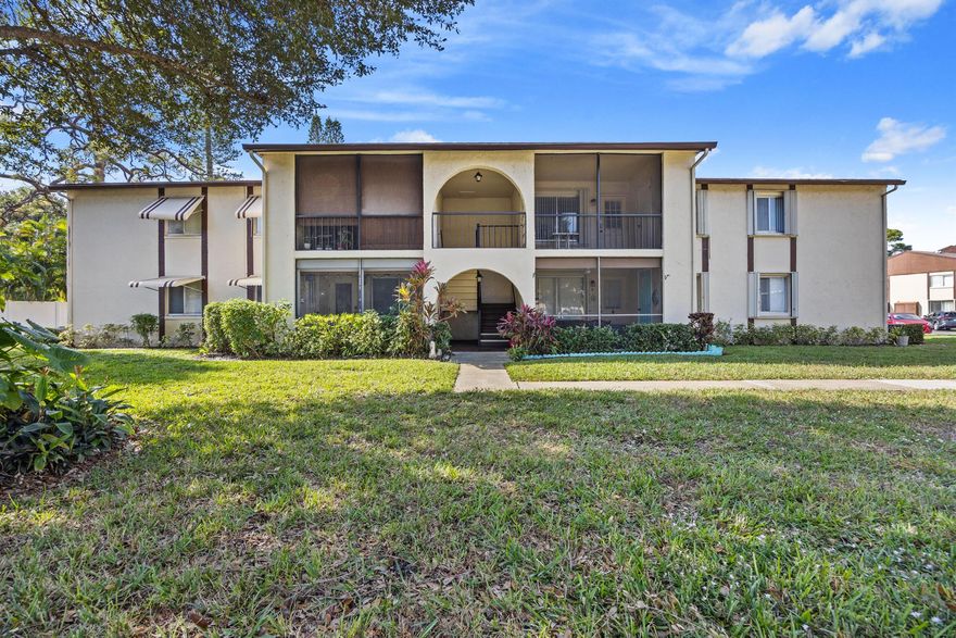 Low price for this fully-furnished 2nd floor 2 bedroom condo with a nice open floor plan! Spacious living and dining area. Each bedroom has its own walk-in closet. Full-size washer and dryer in separate laundry room. Accordion hurricane shutters for your protection. Screened patio with a convenient storage room. NEW ROOF 2025 without assessments.  Located in La Pinata, a well-managed 55+ community with a clubhouse, pool, bocce, shuffleboard, a scenic walk-in path around a pretty lake, and close to the Turnpike. Condo fees include cable and internet.