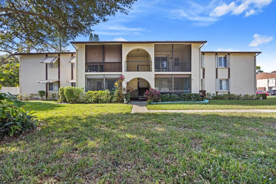 Low price for this fully-furnished 2nd floor 2 bedroom condo with a nice open floor plan! Spacious living and dining area. Each bedroom has its own walk-in closet. Full-size washer and dryer in separate laundry room. Accordion hurricane shutters for your protection. Screened patio with a convenient storage room. NEW ROOF 2025 without assessments.  Located in La Pinata, a well-managed 55+ community with a clubhouse, pool, bocce, shuffleboard, a scenic walk-in path around a pretty lake, and close to the Turnpike. Condo fees include cable and internet.