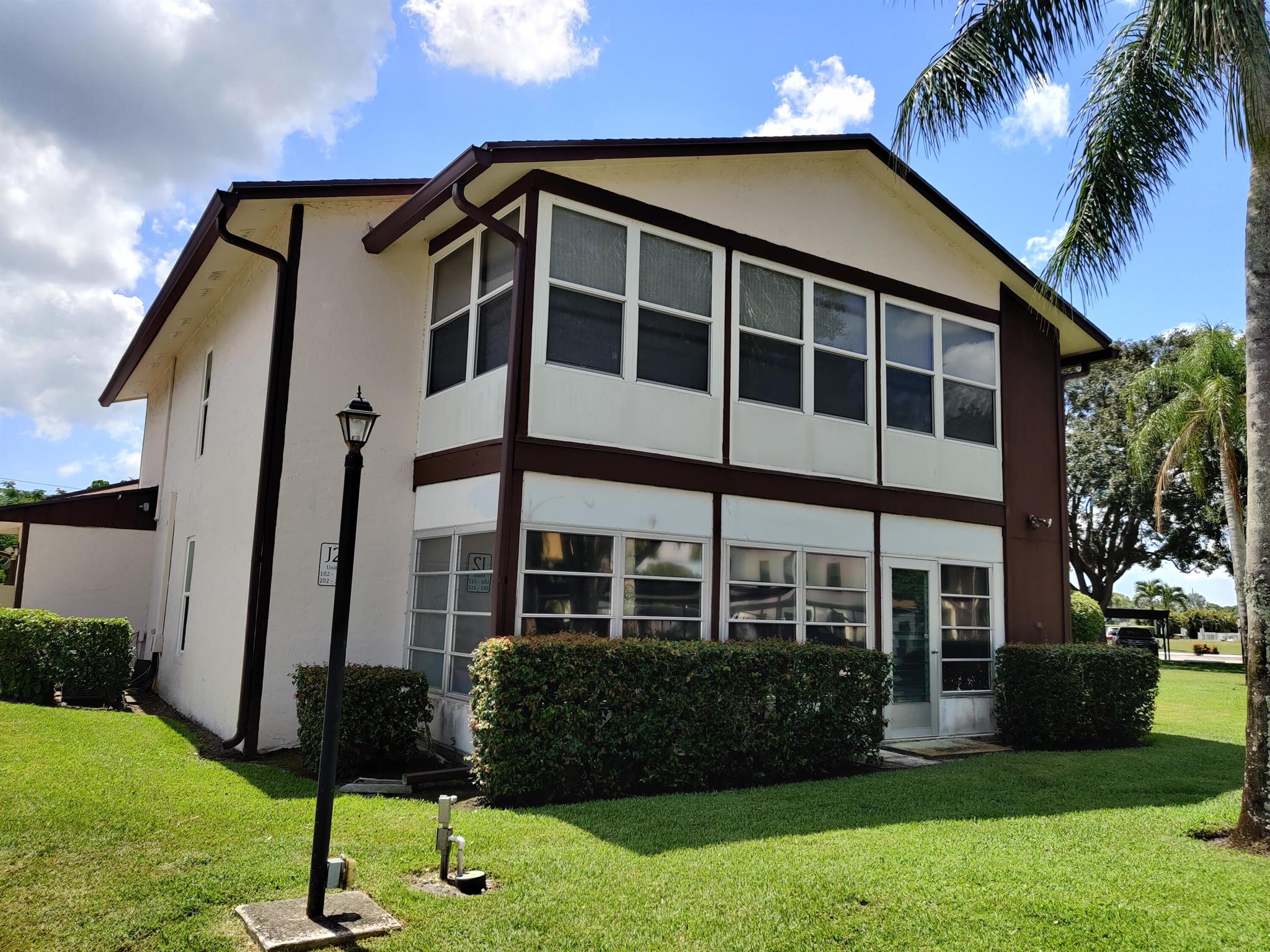 Outstanding Value! 2/2 end unit w/1 car carport in South Stuart area of Twin Lakes. Roof 2022, PGT impact windows 2022, A/C 2024. Split BR plan w/spacious master BR & large 2nd BR. Assigned covered carport space, very close to unit. Partial updates. Nice kitchen opens onto dining area/living room. 2nd floor location, but easy stairs w/a landing. Washer & dryer in hall closet area. Patio/Florida room with white single hung windows + storage room. Active 55+ community w/pool, fitness area, tennis/pickleball, shuffleboard, BBQ area, library & activities. On-site management. Condo dues include bldg. insurance, cable, common area maintenance, reserves & community amenities. 1 pet allowed up to 20 lbs. No waiting period after purchase on rentals. Enjoy the good life at Twin Lakes!