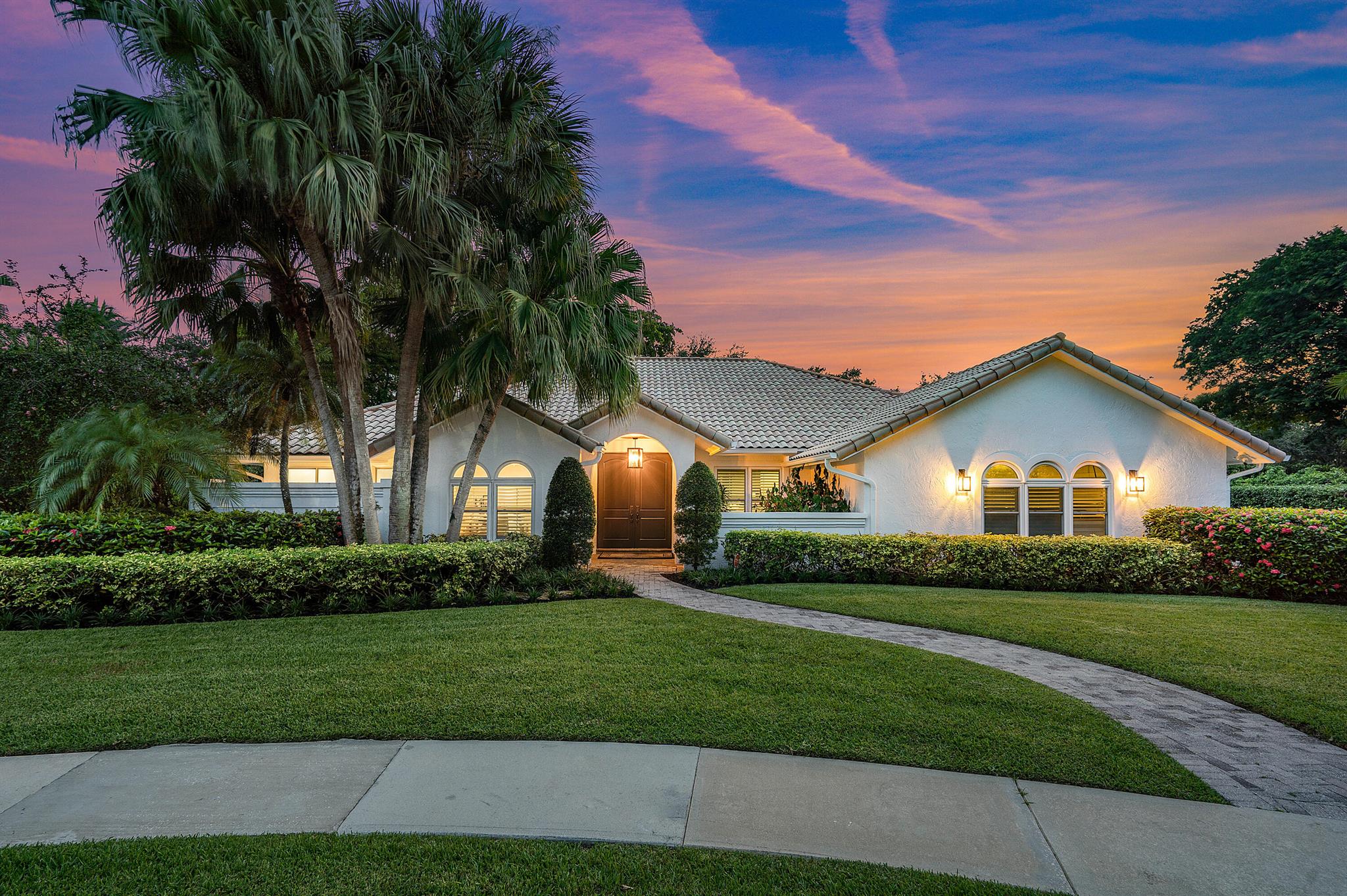 Dictionary's definition of ''Stunner:'' a person or thing of striking excellence, beauty, achievement, etc... You will get just that HERE at 4125 NW 24th Ter .. The best-priced estate in one of Boca Raton's most sought-after guard gated communities, Les Jardins. Step inside this totally remodeled 4-bed/3-bath home sprawling across a triple-split floor plan with high-vaulted ceilings and open concept across nearly 3,000 living SF. An unbelievable kitchen equipped with an oversized island with a quartz waterfall countertops, an abundance of cabinet and counterspace, GE Monogram Appliances, Designer herringbone subway tile backsplash, coffee and breakfast bar/dual ovens .. all opening into your beautiful family room. Professionally designed entertainment center and gorgeous dining room