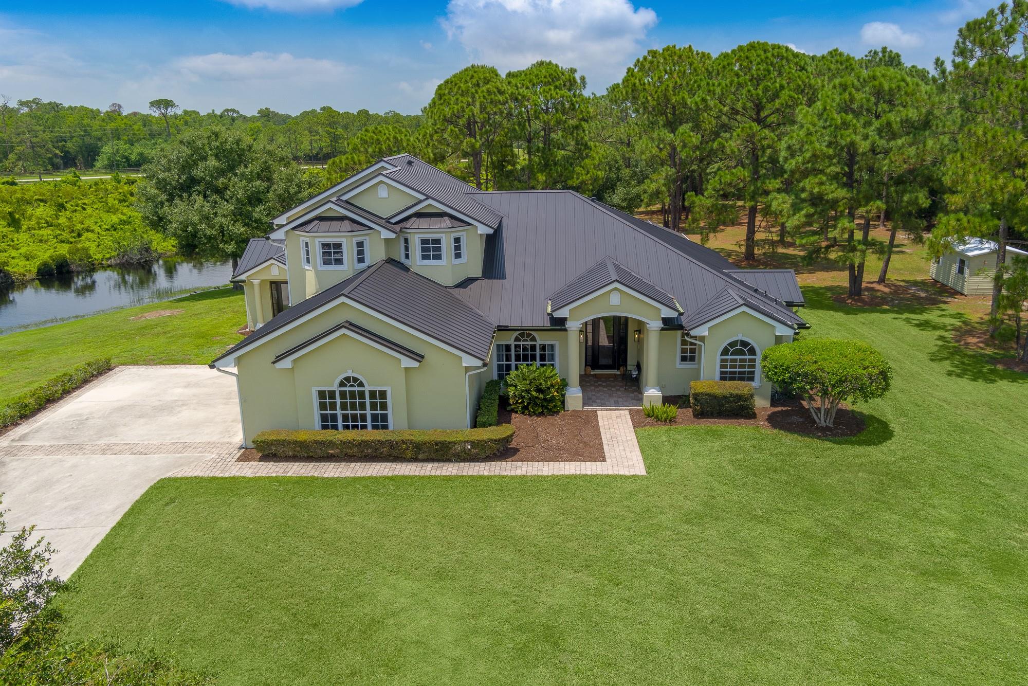 Outdoor lovers—welcome to Stuart West, a prestigious gated community in Palm City! Available to lease for the first time, this private estate sits on over 7 acres in a cul-de-sac with preserve and water views. With 4 bedrooms, 4 bathrooms, and 3,400+ sq ft of remodeled living space, it’s perfect for everyday luxury and entertaining. Features include a chef’s kitchen, guest suite, office/art studio, large patio, pool/spa, and a 3-car epoxy garage. Recent upgrades: metal roof, new flooring, paint, and new water heater. Central vac system included. Rent is all-inclusive: pool, lawn, water treatment, and HOA.