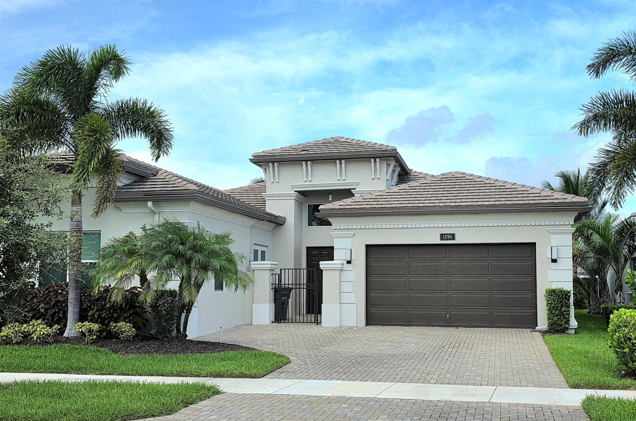 Welcome to this beautifully maintained, lakefront home located in the highly sought-after Valencia Bay, a premier 55+ community offering a luxurious and active lifestyle. This elegant 3-bedroom, 2.5-bath residence with an additional multi-use flex room and 2-car garage spans 2,827 sq. ft. of thoughtfully designed living space. From the moment you enter, you'll be greeted by an open and airy layout with expansive lake views, impact glass windows throughout, and neutral porcelain tile flooring--no carpet in sight. The heart of the home is a gourmet kitchen that will impress any chef, featuring a center island, stunning quartz countertops, custom cream-colored cabinetry, herringbone tile backsplash, a double oven, and a cozy breakfast area. A formal dining room and spacious living area
