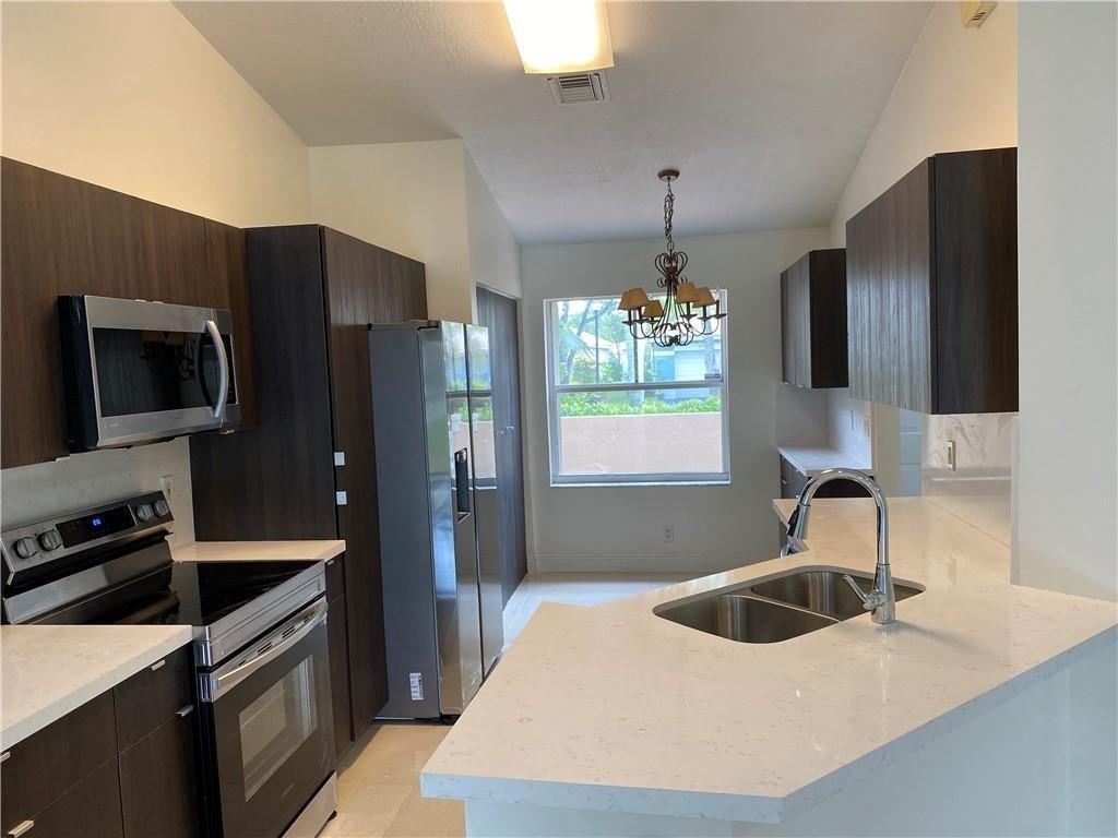 TOTALLY RENOVATED SINGLE STORY HOME IN WESTON! This property features a CONTEMPORARY KITCHEN with quartz countertops and stainless steel appliances. Beautiful porcelain tiles in living areas and bedrooms. Both bathrooms have been completely renovated. Modern recessed lighting, zebra blinds & ACCORDION SHUTTERS. This home is located in THE RIDGES guard gated community with pool, playground, pickleball courts, basketball courts, volleyball court & more! Great location close to A RATED PUBLIC SCHOOLS, restaurants, shops, and easy access to highways. RENT INCLUDES LAWN MAINTENANCE. NO HOA APPROVAL.