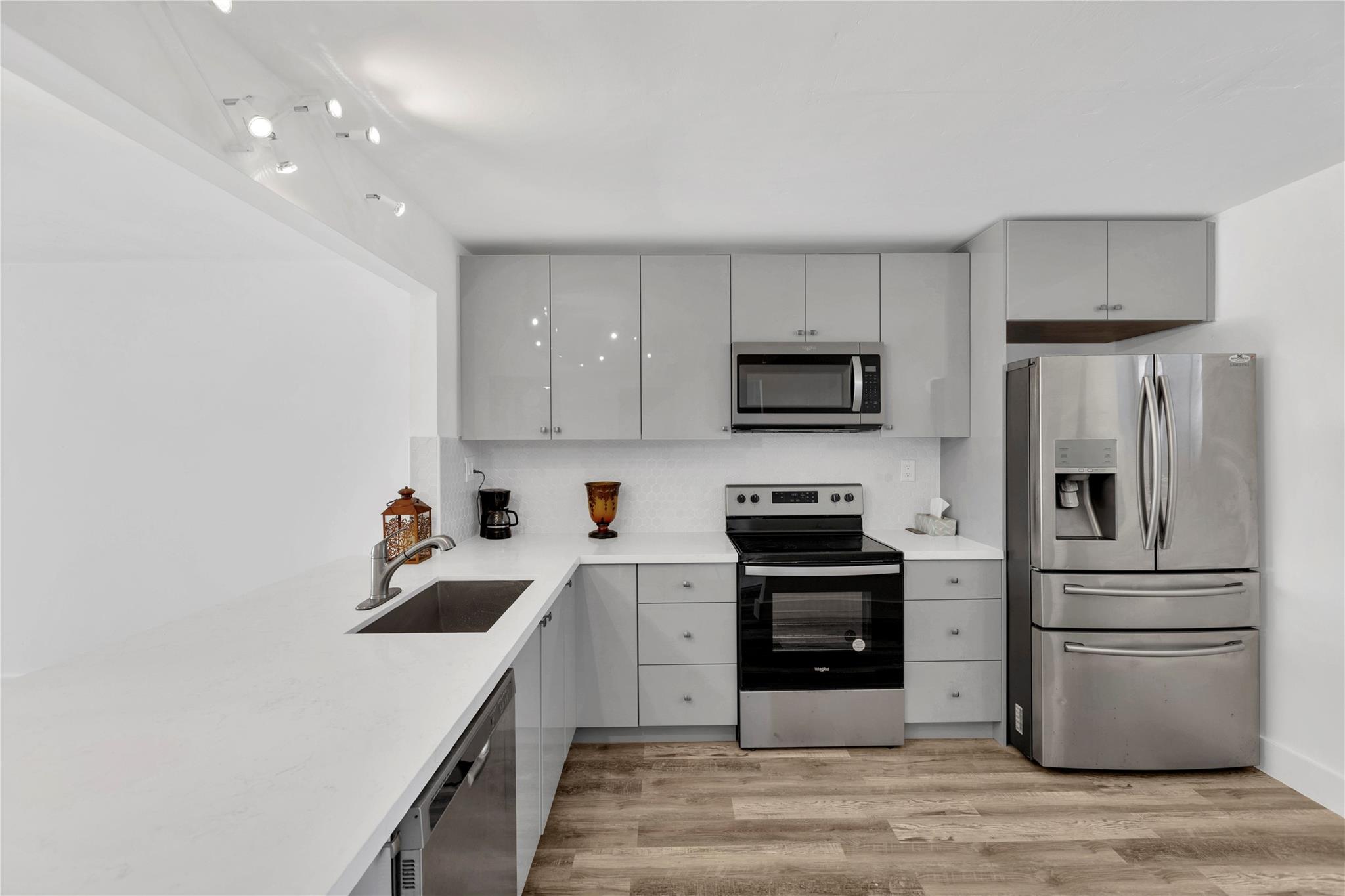 Just listed and priced to sell! This beautifully renovated 2-bedroom, 2-bath condo boasts a European-style open kitchen with wood cabinetry, quartz countertops, tiled backsplash, and stainless steel appliances. Waterproof flooring extends throughout the home for easy maintenance. The spacious master suite features dual walk-in closets, complemented by two fully updated modern bathrooms. Relax on the large screened patio with serene views of the pool area. Situated in a secure, 24/7 gated 55+ community offering tennis courts, a heated pool, clubhouse, BBQ area, and more. Conveniently located close to shopping and dining, this move-in-ready home is a rare find!