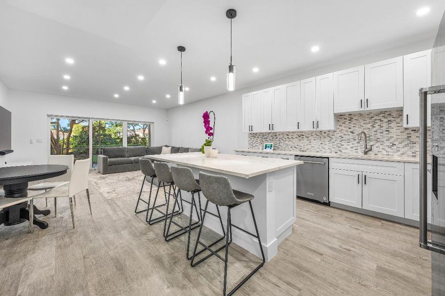 Enjoy the ease of this completely renovated first-floor condo, where bright interiors and a clean, modern canvas set the stage for a move-in-ready space. Subtle contemporary touches are throughout, creating a sophisticated atmosphere. The streamlined kitchen, anchored by a generously sized island, invites both everyday living and effortless entertaining, opening naturally into the family room. A screened-in patio creates a charming space with tranquil garden views, perfect for pausing and recharging. The private primary suite sits on its own for maximum privacy, and offers two walk-in closets and a spa-inspired bath with dual vanities and a freestanding soaking tub. Three additional bedrooms provide flexible options for guests or a home office. A well-appointed laundry room delivers abundant storage and connects to the one-car garage. With impact windows and doors, the home offers an added layer of protection. Positioned just across from the Coquina Isle satellite pool and gym, you're moments from convenient neighborhood amenities, along with full access to The Polo Club's extensive offerings at the Clubhouse.