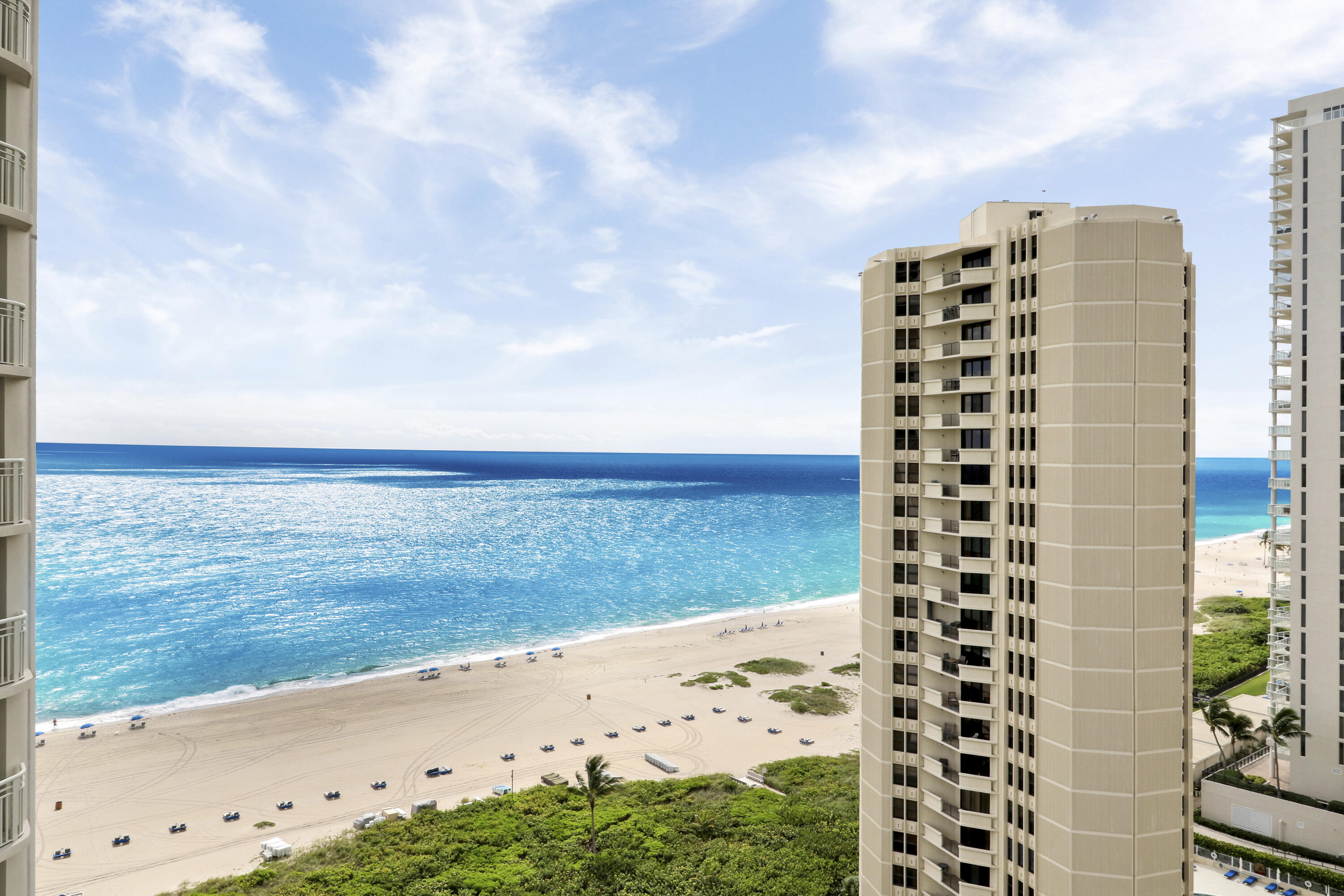 Experience both sunrise over the Atlantic and sunset over the Intracoastal from this 19th floor residence in Tiara on Singer Island! This fully furnished, turnkey condo showcases floor-to-ceiling sliding glass doors with balcony access from both bedrooms and the living room.A fully renovated kitchen with stainless steel appliances, paired with a split-bedroom floor plan and in-unit washer/dryer for convenience.Tiara offers a true resort lifestyle: 24-hour concierge, valet, and manned gate, oceanfront heated pool with separate jacuzzi, tennis courts, men's & women's fitness centers with steam rooms, and a guest suite for visitors. At the crown of the building, residents and guests can dine at the rooftop restaurant & lounge featuring 360 panoramic views--a signat