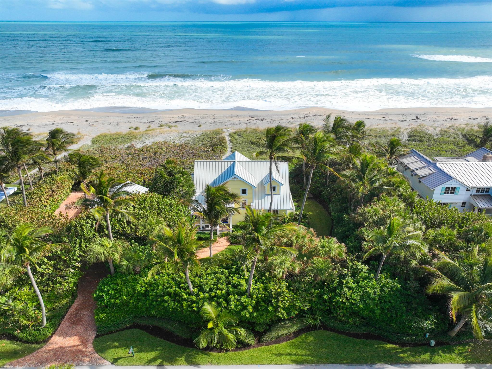 Charming and pristine beach front home with 150' of ocean frontage on coveted Jupiter Island. Magnificent wide ocean views from the primary suite with French doors leading to a covered balcony. Home features concrete construction with impact windows & doors, two-car garage, IPE porch & decks, stainless steel appliances including gas stove, tile & hardwood flooring, and outdoor shower. Mature lush tropical landscaping, Chicago brick driveway and paths. Minutes to town, restaurants, shopping, and Palm Beach International Airport.